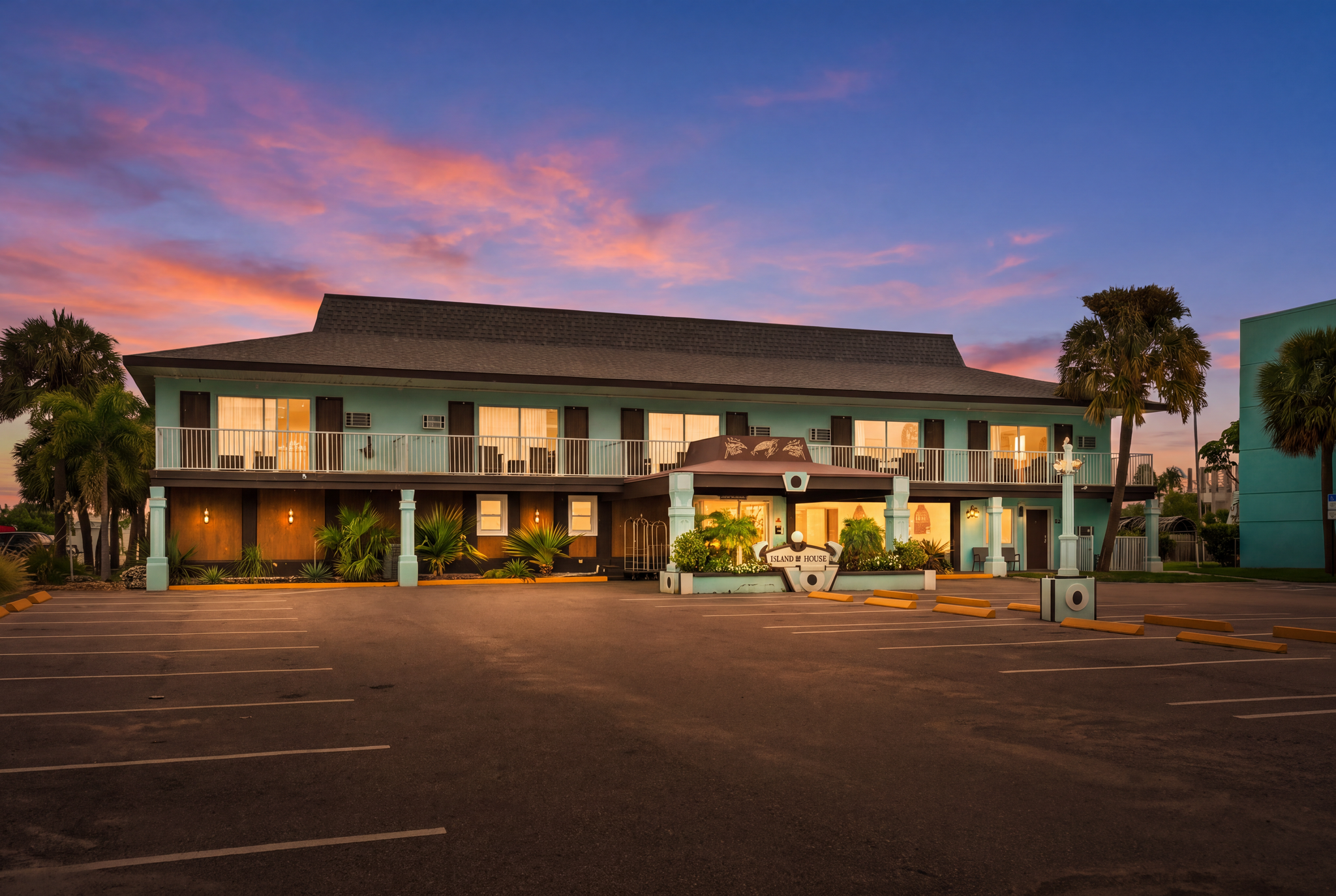 Island House Resort Hotel exterior at sunset with palm trees on Gulf Blvd, North Redington Beach