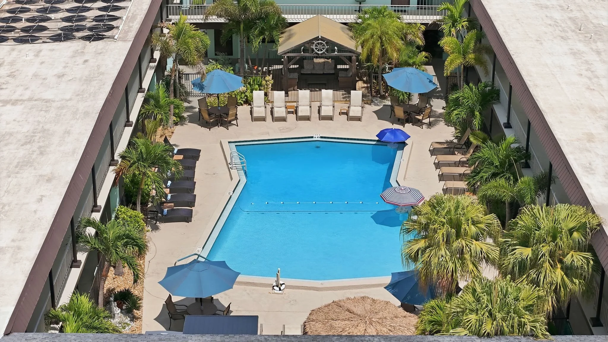 Aerial view of the courtyard pool, cabana and tiki bar at Island House Resort Hotel
