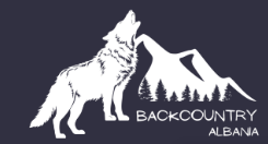 A silhouette of a howling wolf with mountains in the background and the text 'Backcountry Alabama'