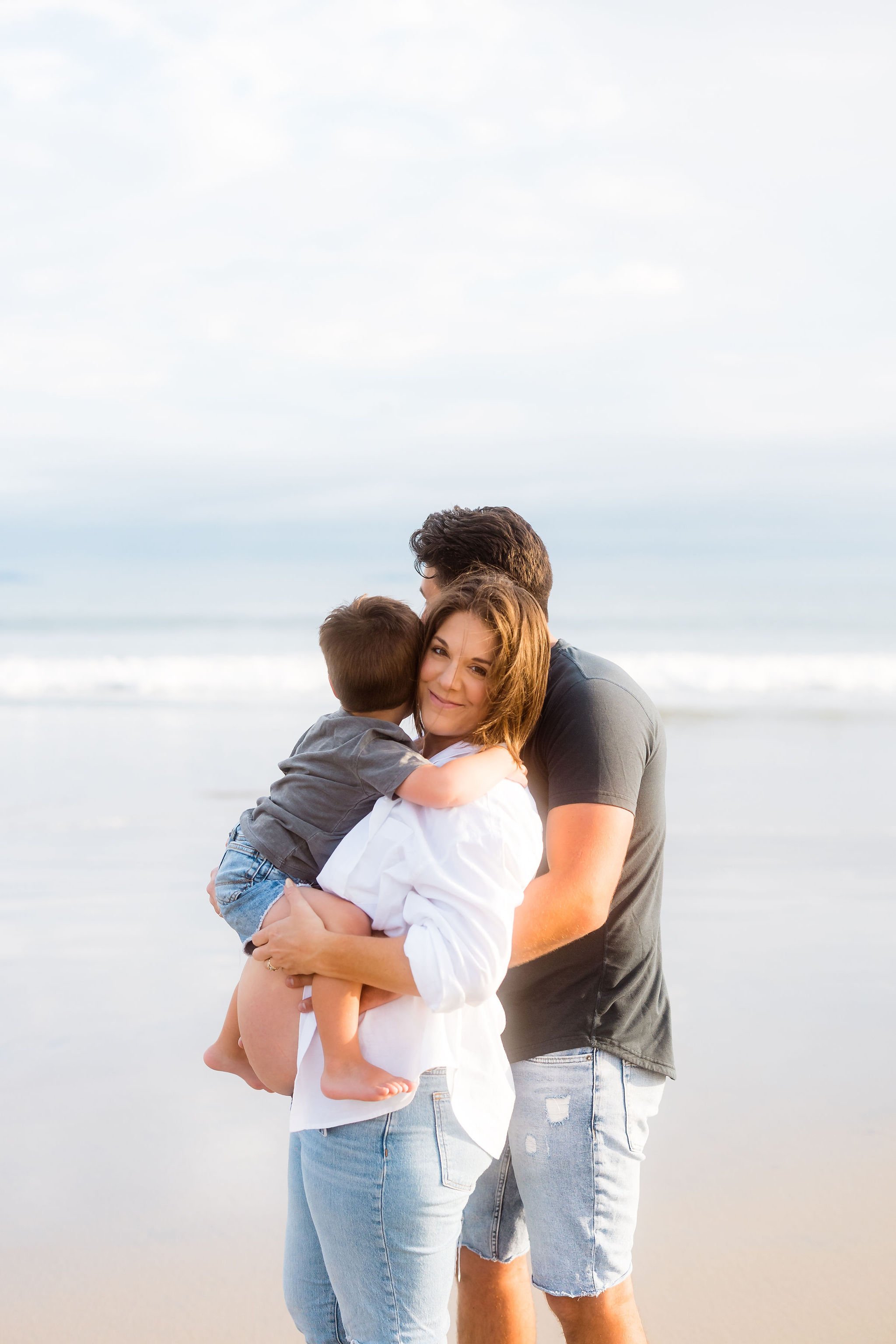 AnnMarie Rose, scaling coach, posing with her family on a beach