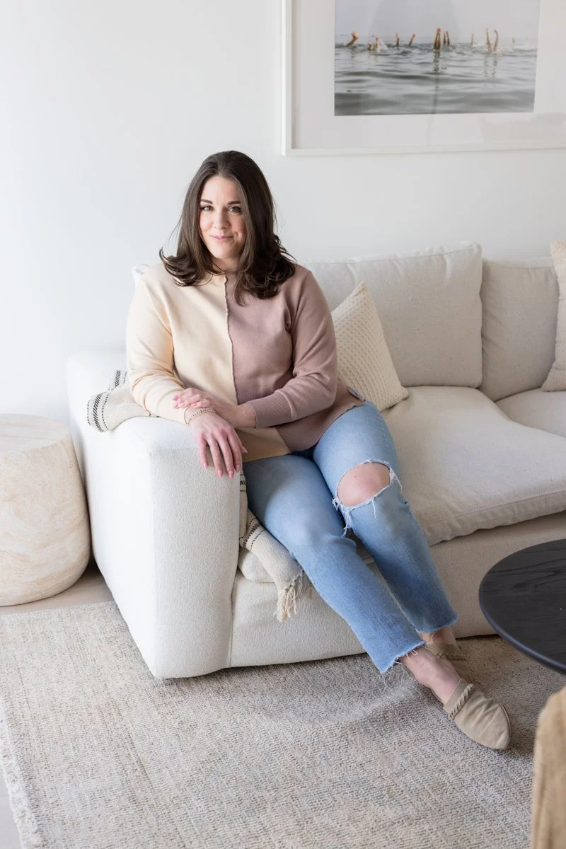 AnnMarie Rose business strategist sitting on a cream-colored couch