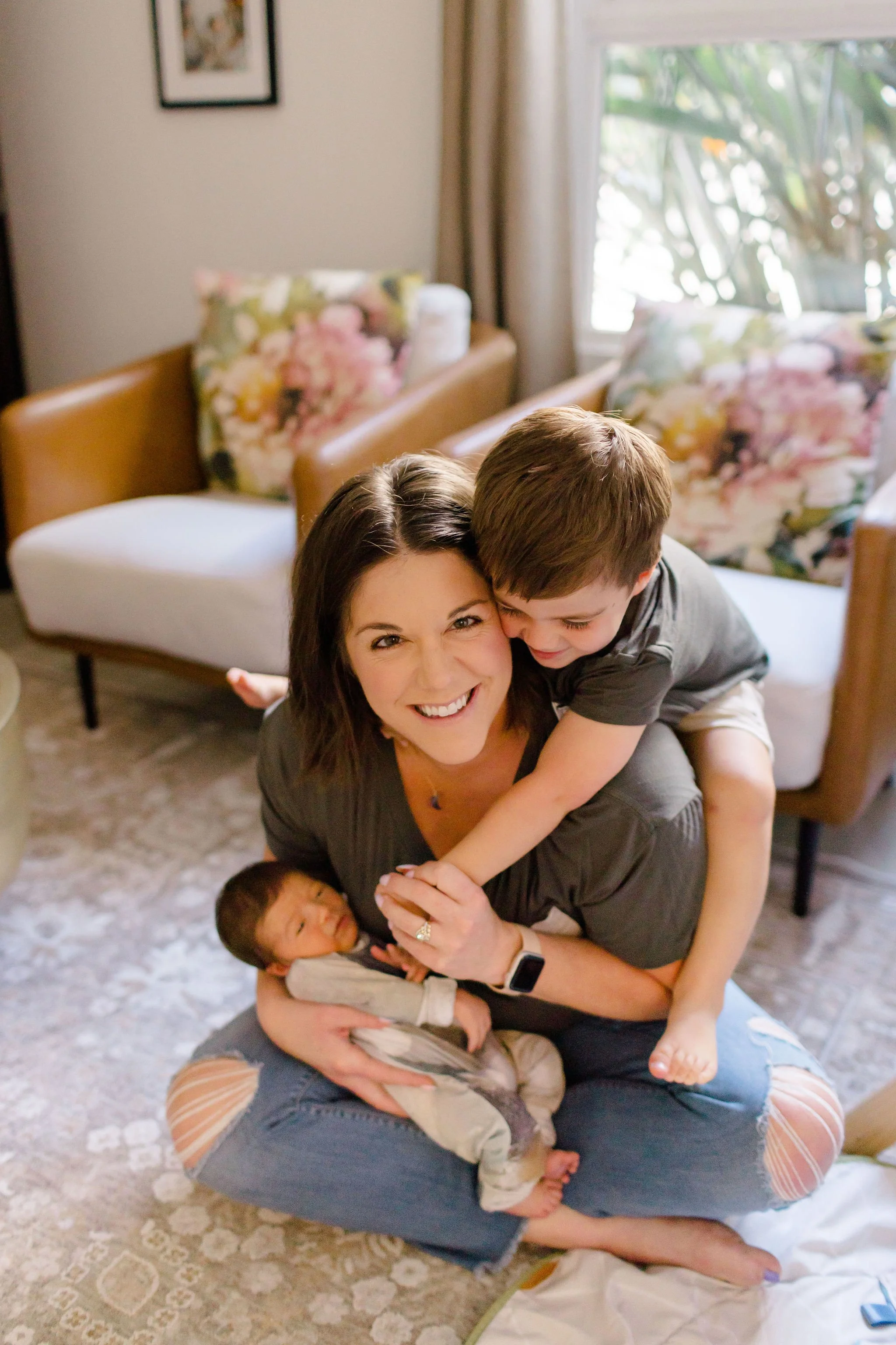 AnnMarie Rose, business coach, sitting on the ground with her two young children