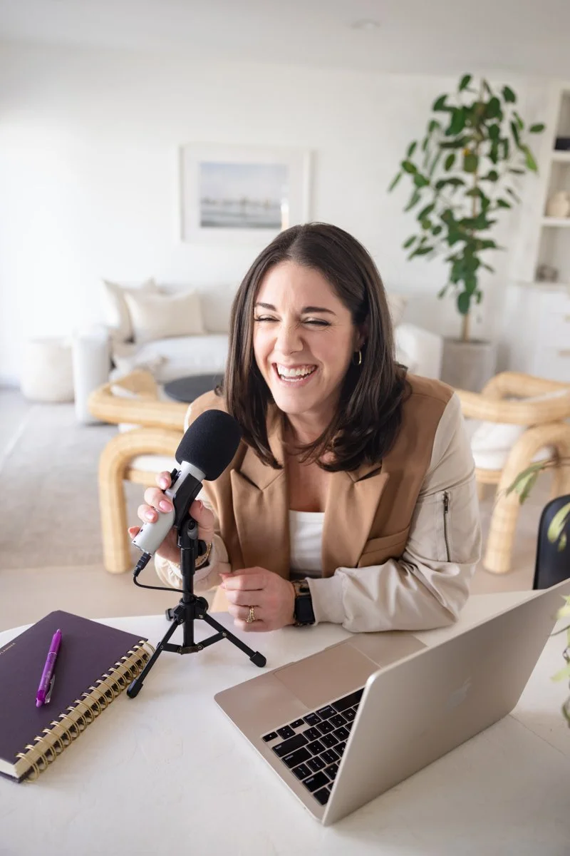 AnnMarie Rose, scaling coach, speaking into a microphone in a home office setting