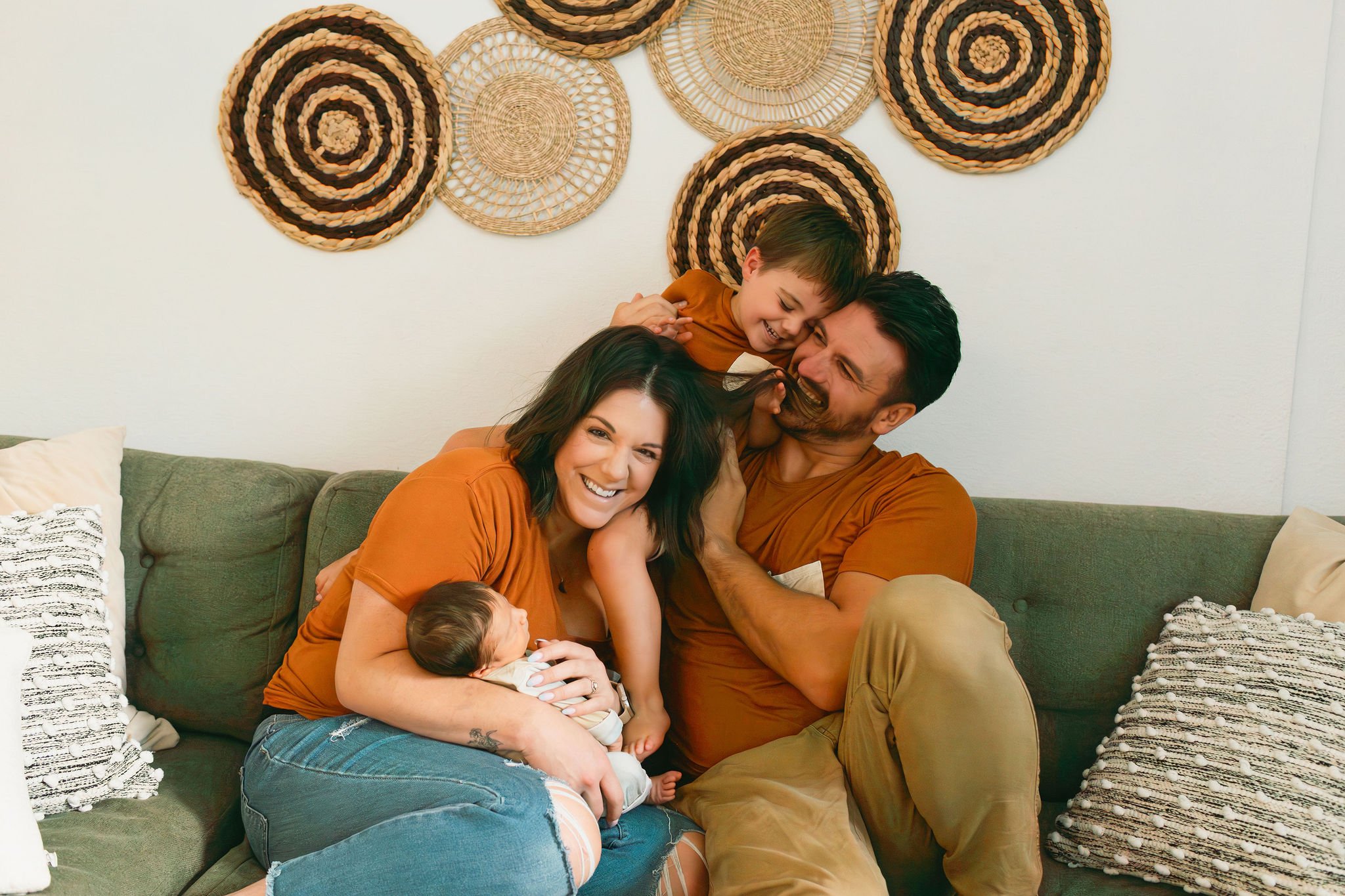 AnnMarie Rose, scaling coach, posing with her family on a green couch