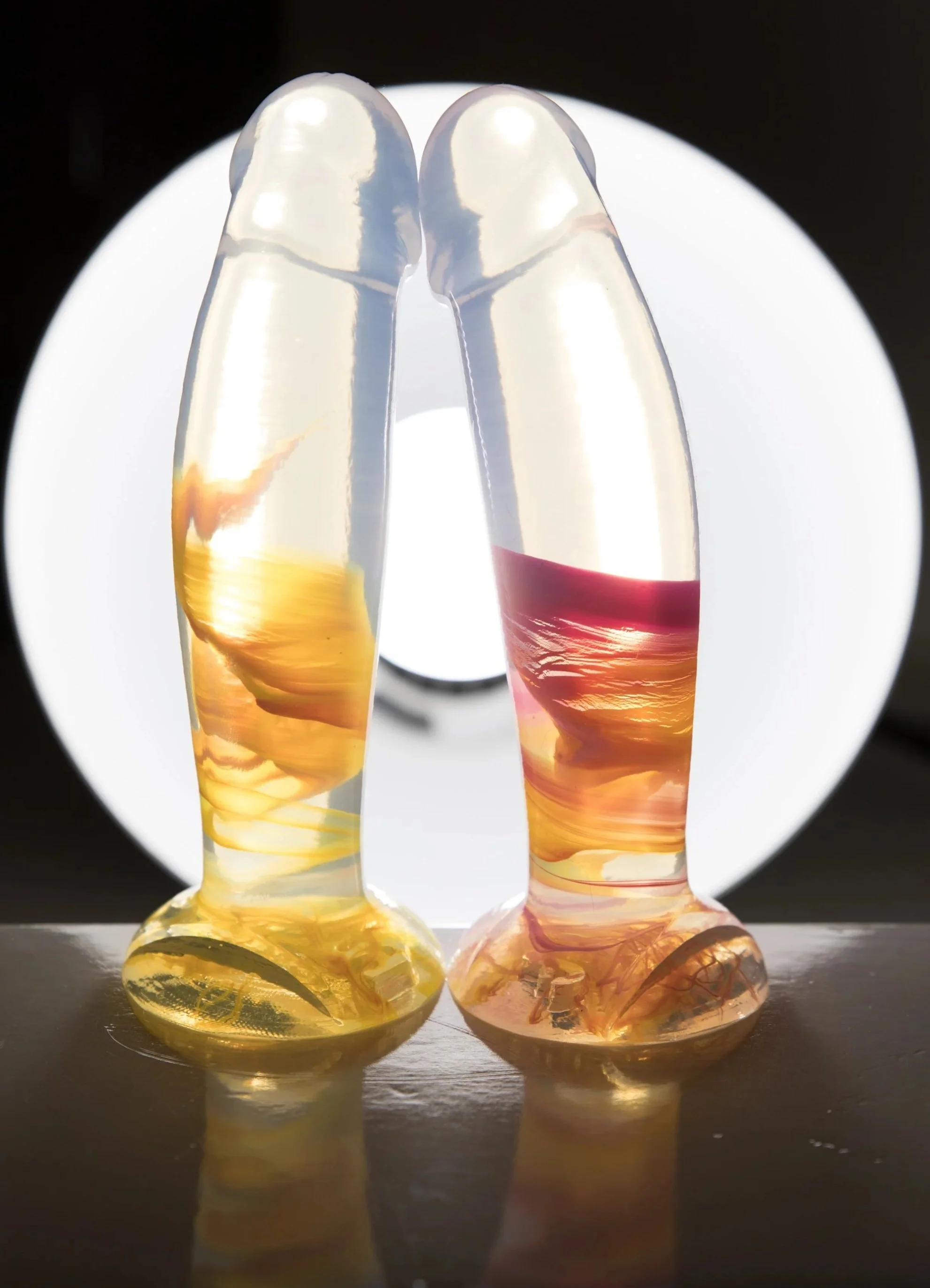 Two clear dildos with sunset swirls