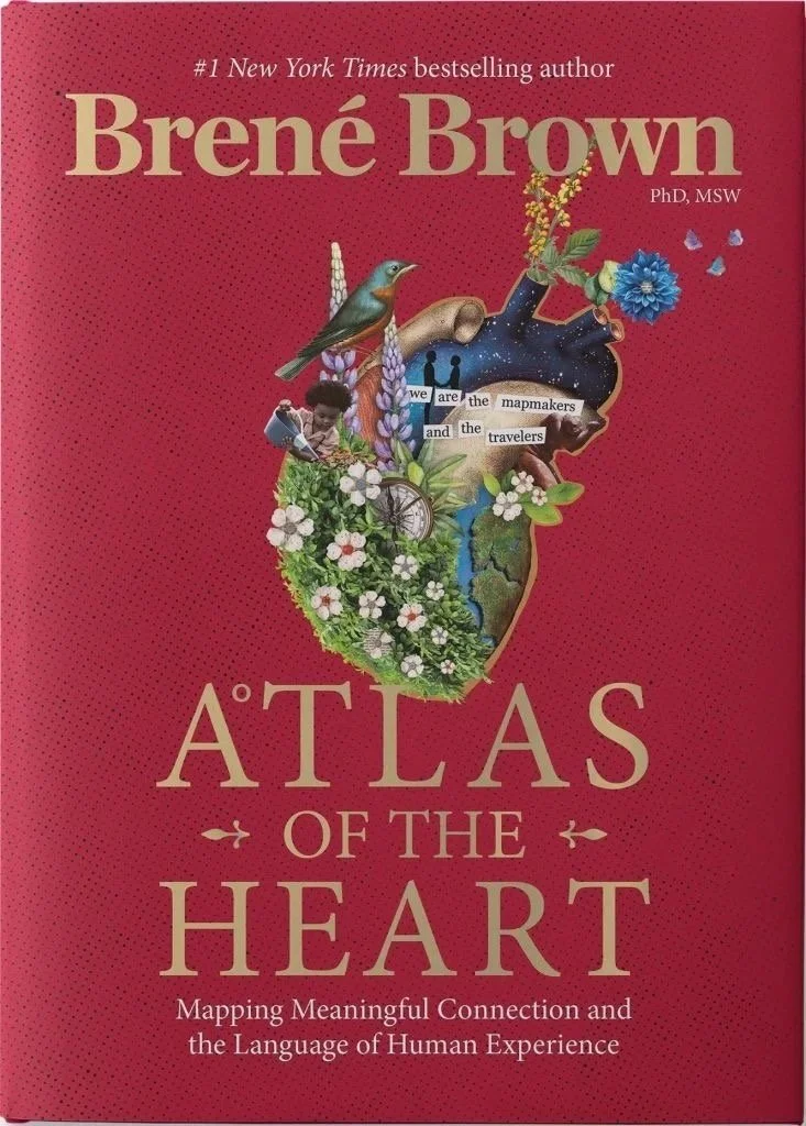 Book cover titled "Atlas of the Heart" by Brené Brown, featuring an illustration of an anatomical heart filled with various images including a bird, a child, flowers, and a map, on a red background.