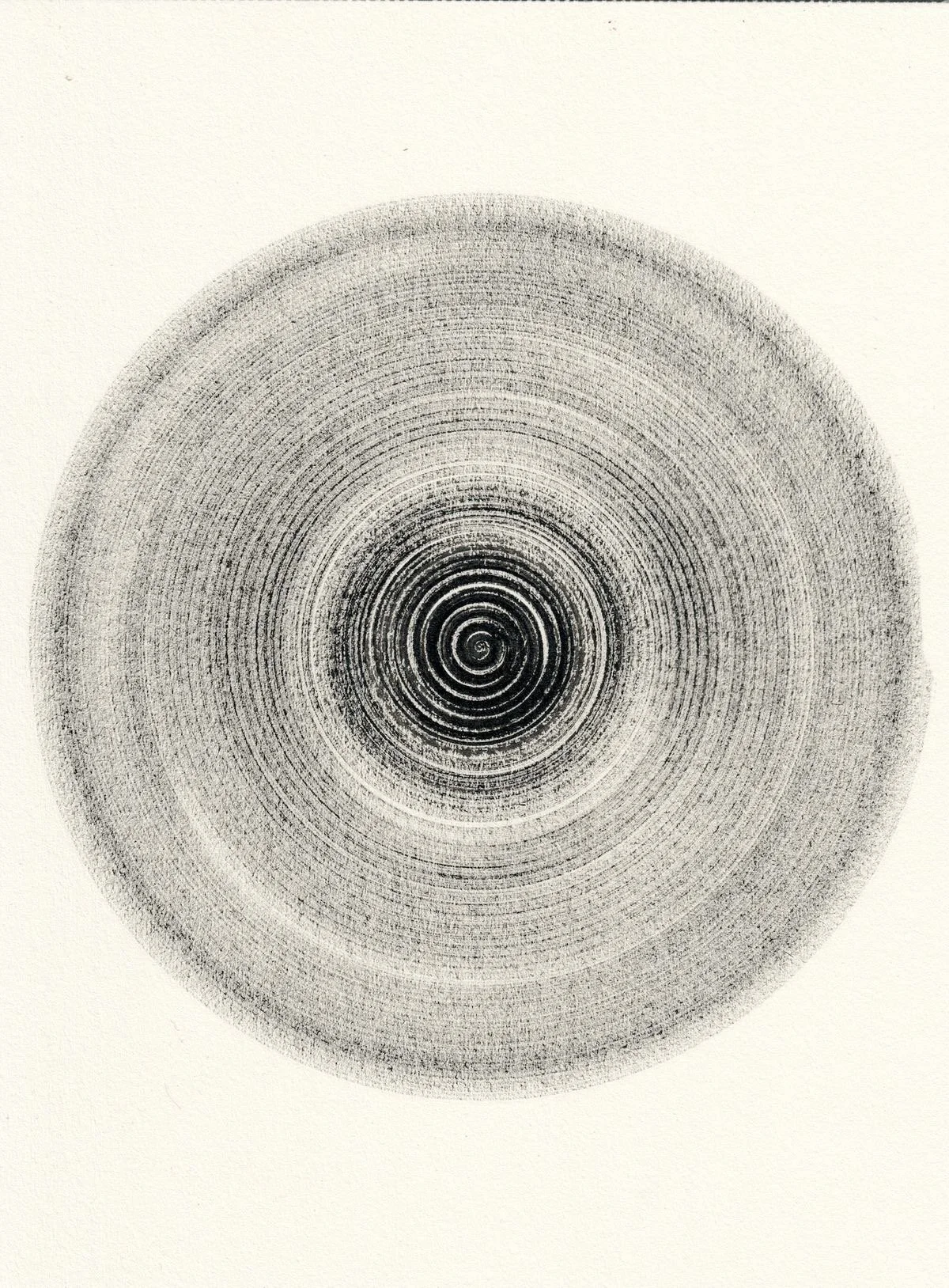A black and white circular pattern with concentric spirals on a light background, resembling a hypnotic or optical illusion design.