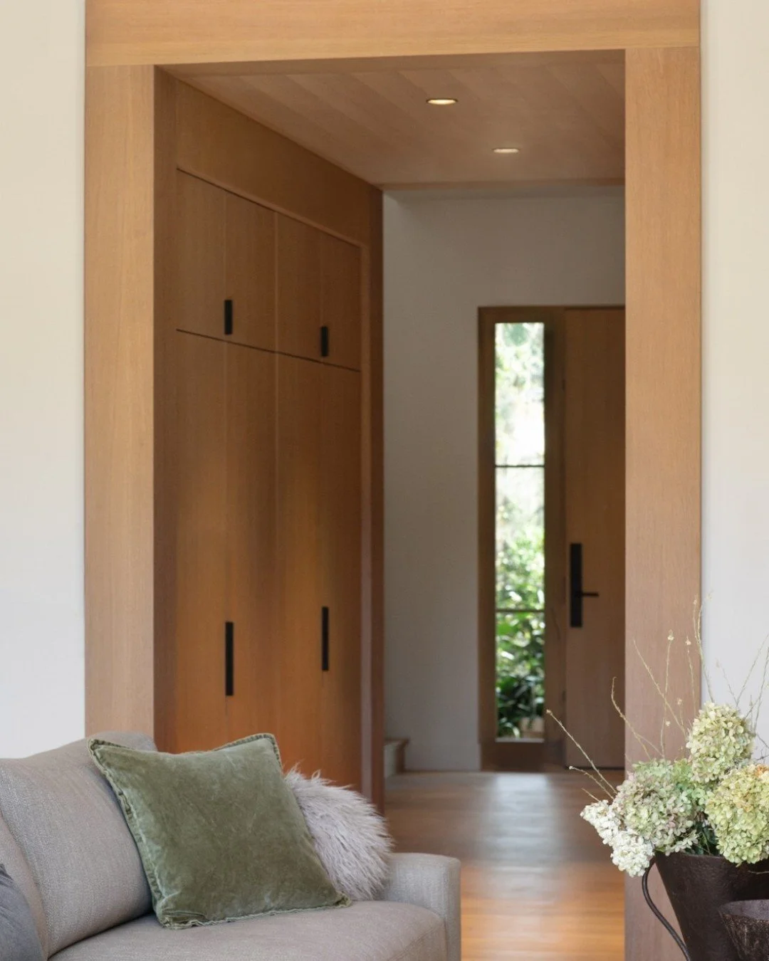 If you know me, you know I love a transition moment. This white oak Vestibule connects the home's formal Entry to the main Living Space. Strong in its architectural expression, the Vestibule also serves as a coat/shoe cabinet, barware storage, and (o