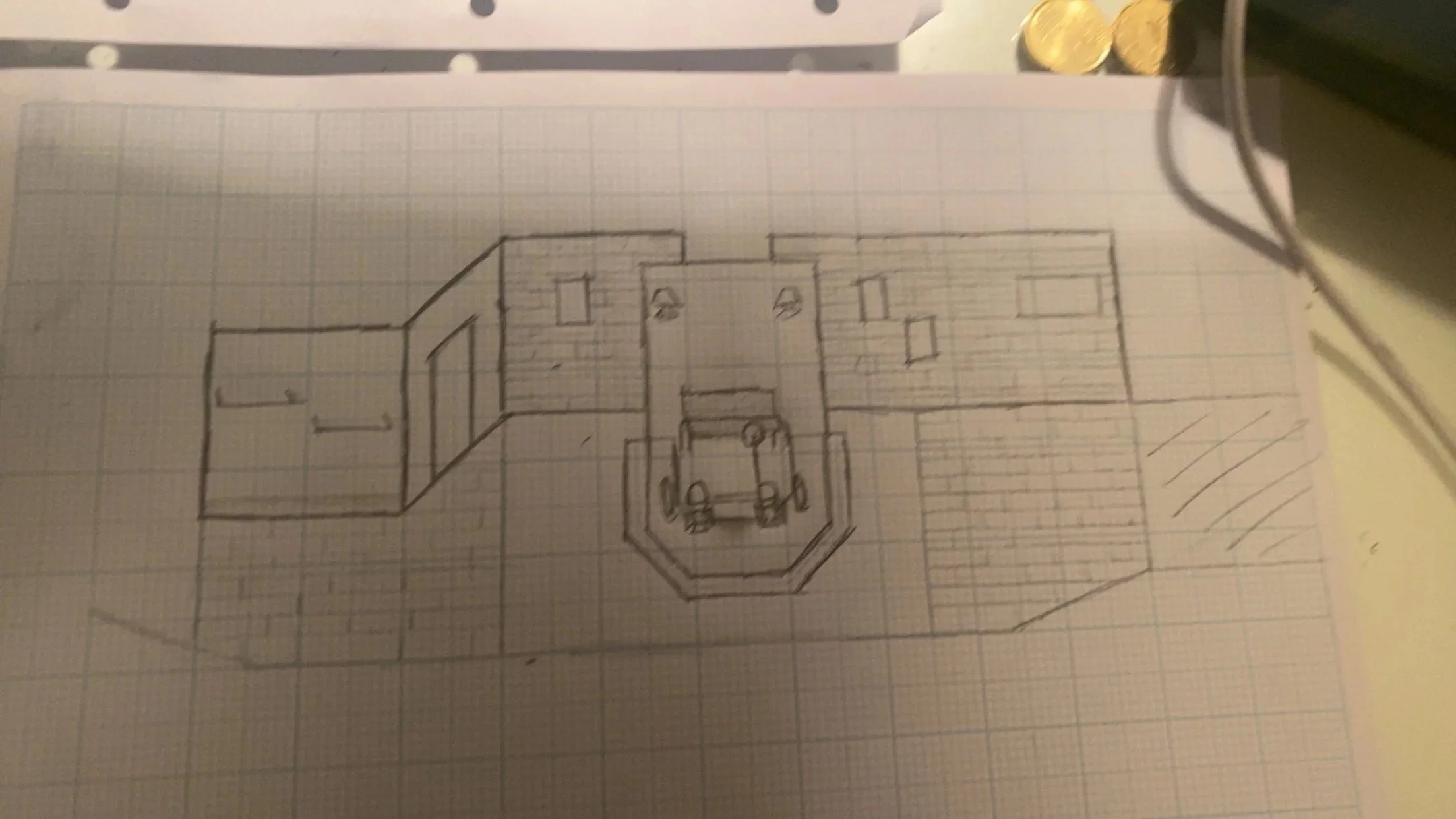 Hand-drawn floor plan on graph paper showing a house layout with rooms, a driveway, and parking spaces.
