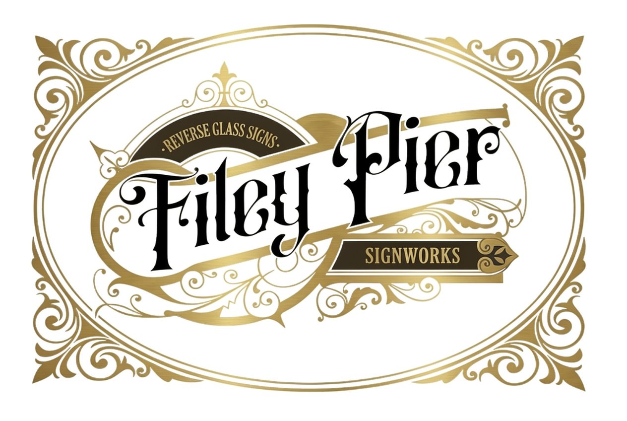 Ornate gold and black sign featuring the text 'Filey Pier Signworks' with a decorative frame and banners indicating 'Reverse Glass Signs'.