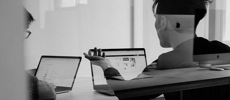 Business leaders discussing digital strategy and online growth with Plugged Digital, specializing in website design, SEO, AI optimization, branding, and digital marketing.