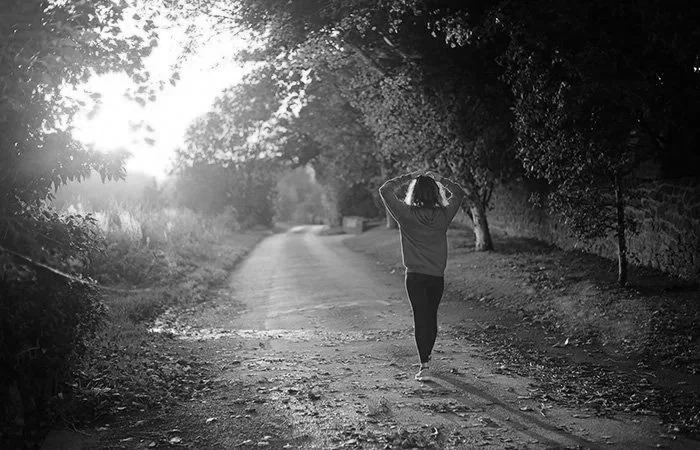 Person walking outdoors as part of a physical therapy and wellness journey, representing healthcare providers focused on patient wellness, rehabilitation, and healthy living.