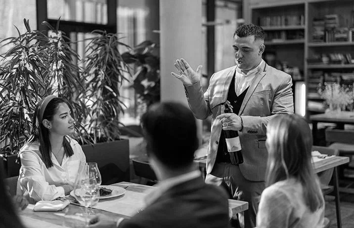 Restaurant professional serving guests, representing restaurants and food service businesses using digital marketing, local SEO, website design, and branding to attract more customers.