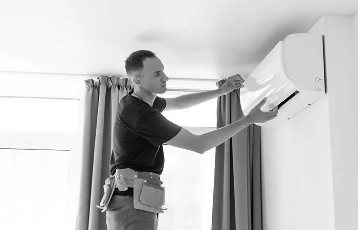 Man working on unit air conditioning