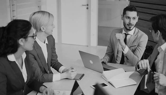 Business professionals discussing public relations, strategic communications, media relations, reputation management, and brand messaging during a planning meeting.