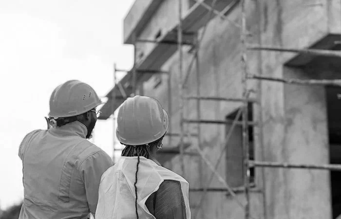 Construction professionals at a commercial job site representing contractors, HVAC, electricians, plumbers, and skilled trades businesses growing through SEO and digital marketing.