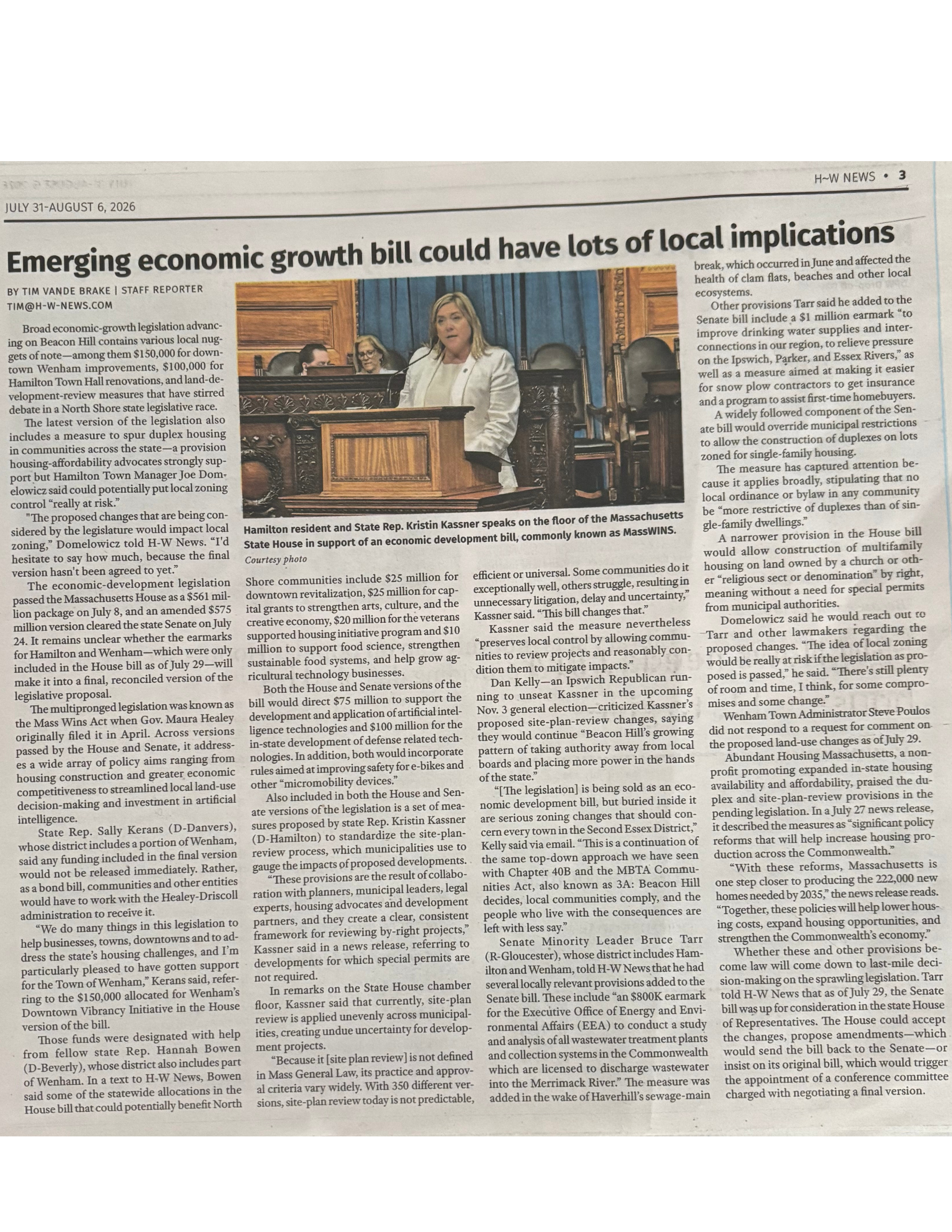A newspaper page featuring an article about emerging economic growth legislation, with a photo of a woman speaking at a government chamber, and other officials seated nearby.