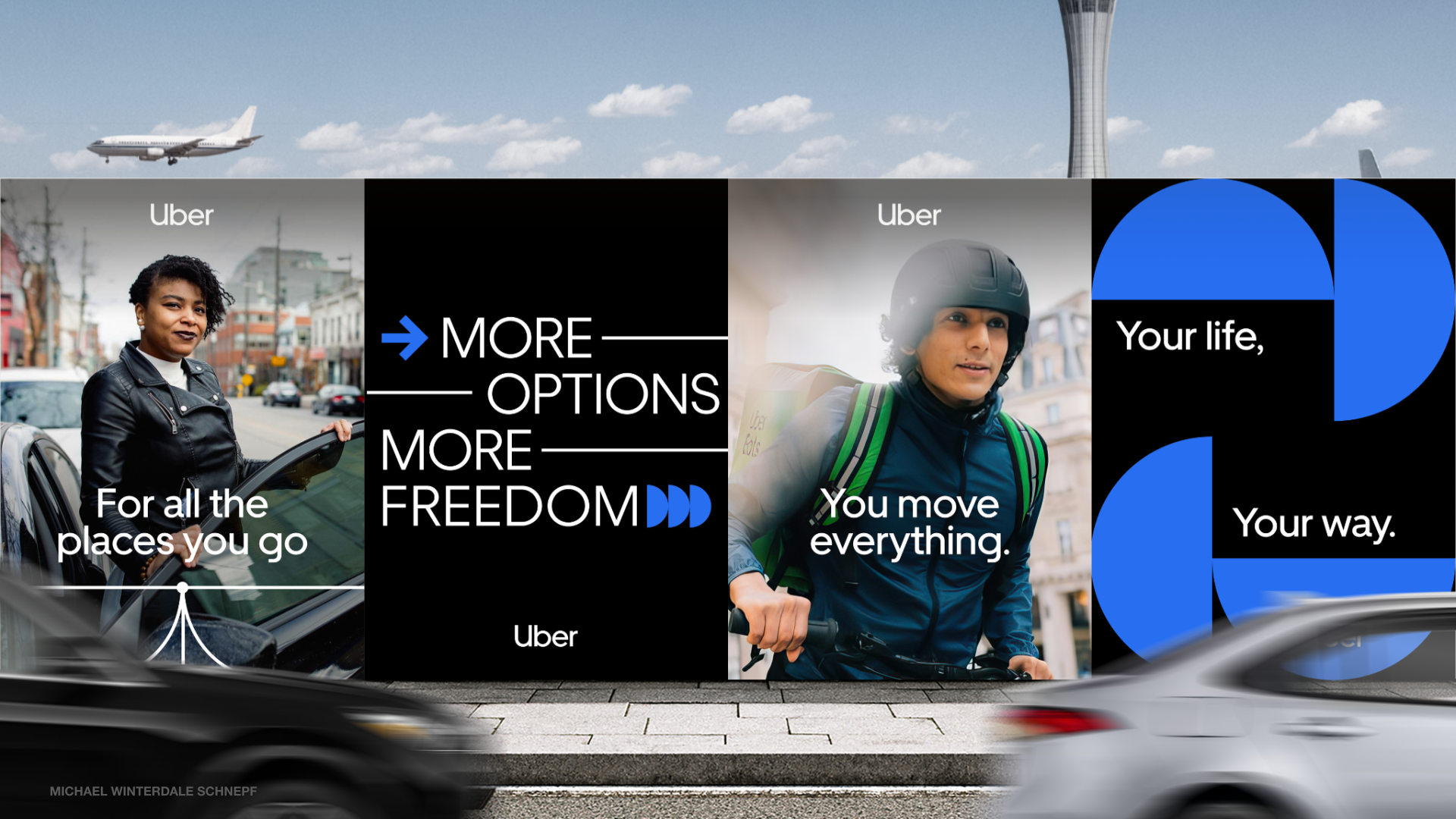 Billboard advertisement for Uber featuring images of a woman opening a car door and a man riding a bicycle, with a cloudy sky and an airplane in the background.