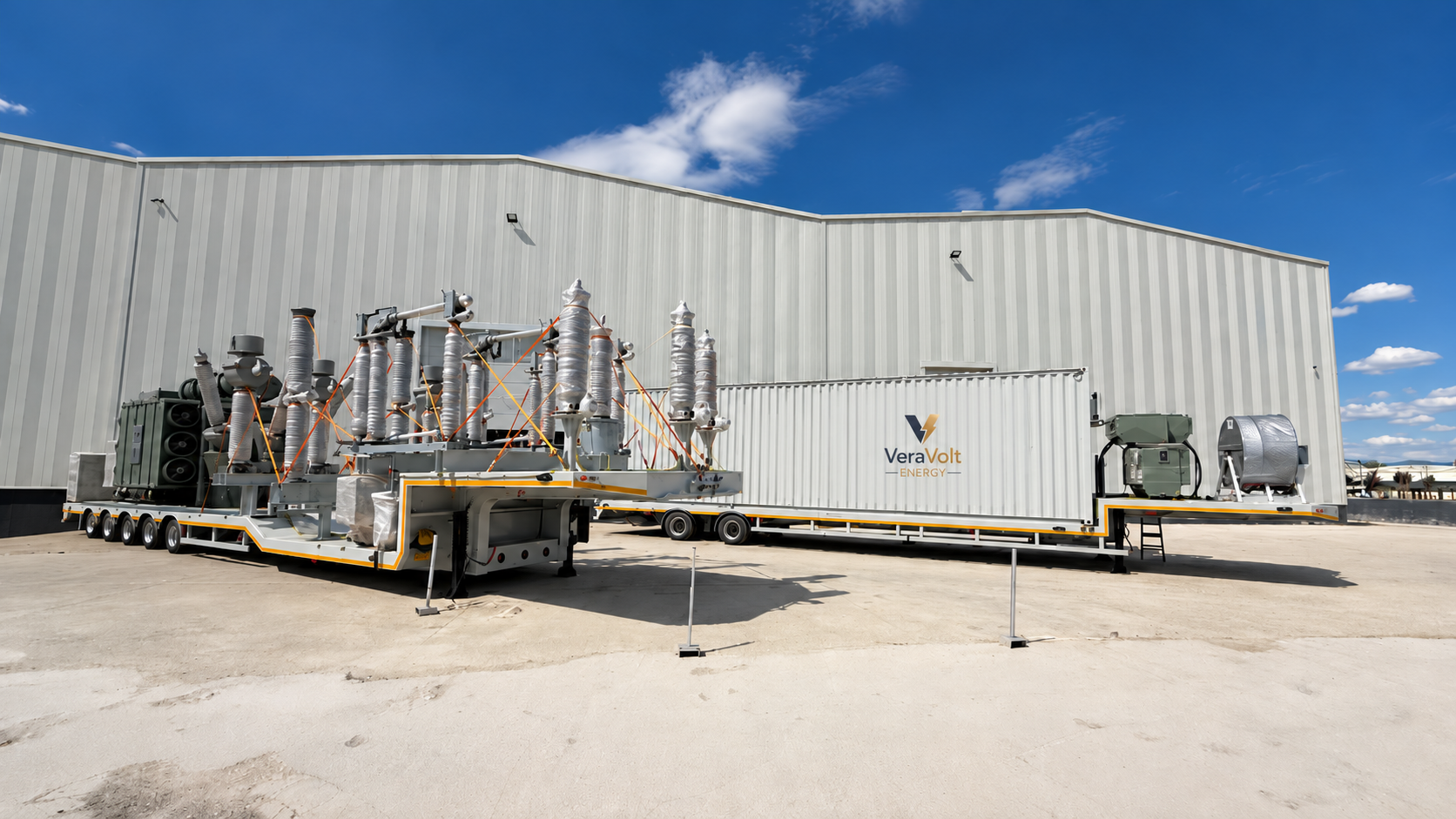 VeraVolt Energy mobile electrical substation equipment on trailers outside an industrial building