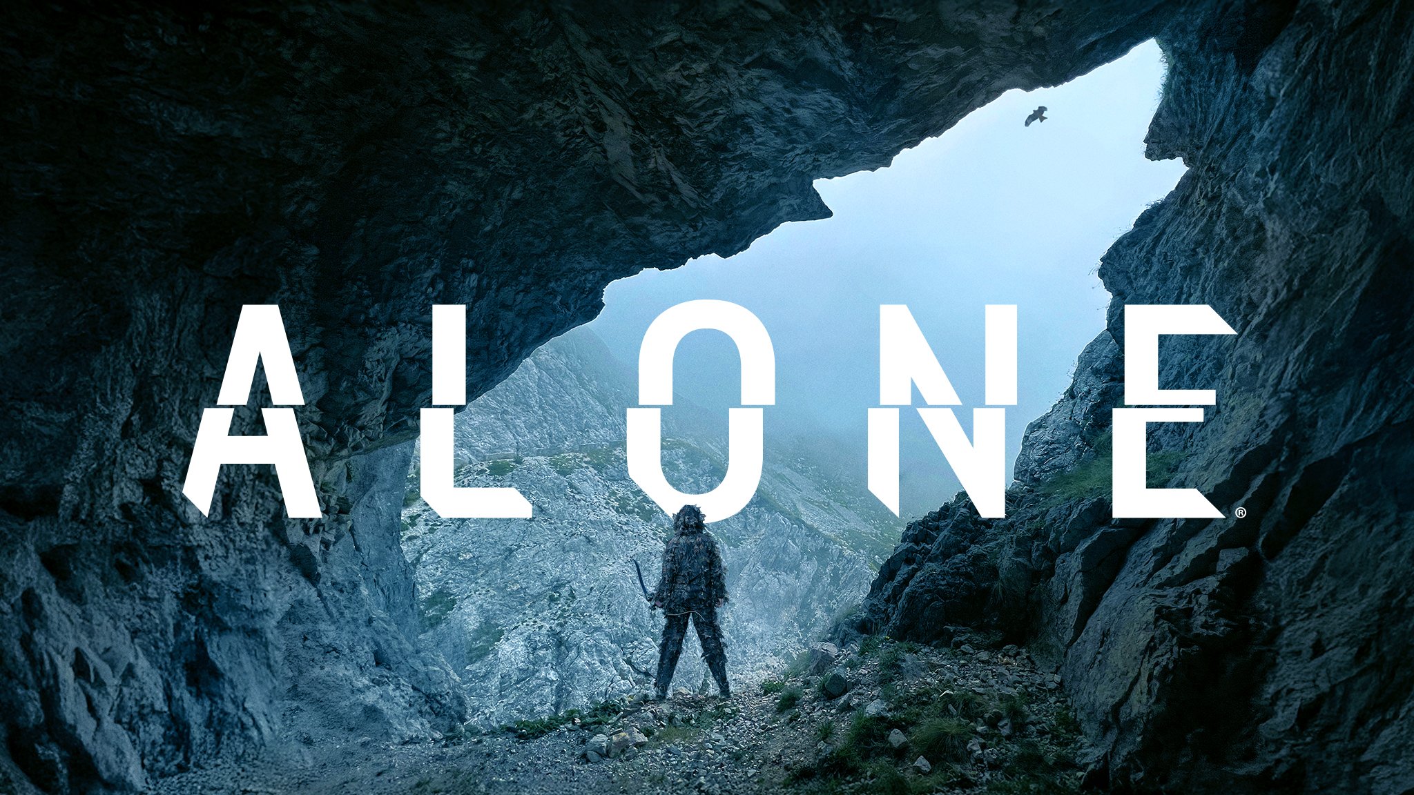 The title card for the TV show Alone. There is a single person in a mountainous scene.