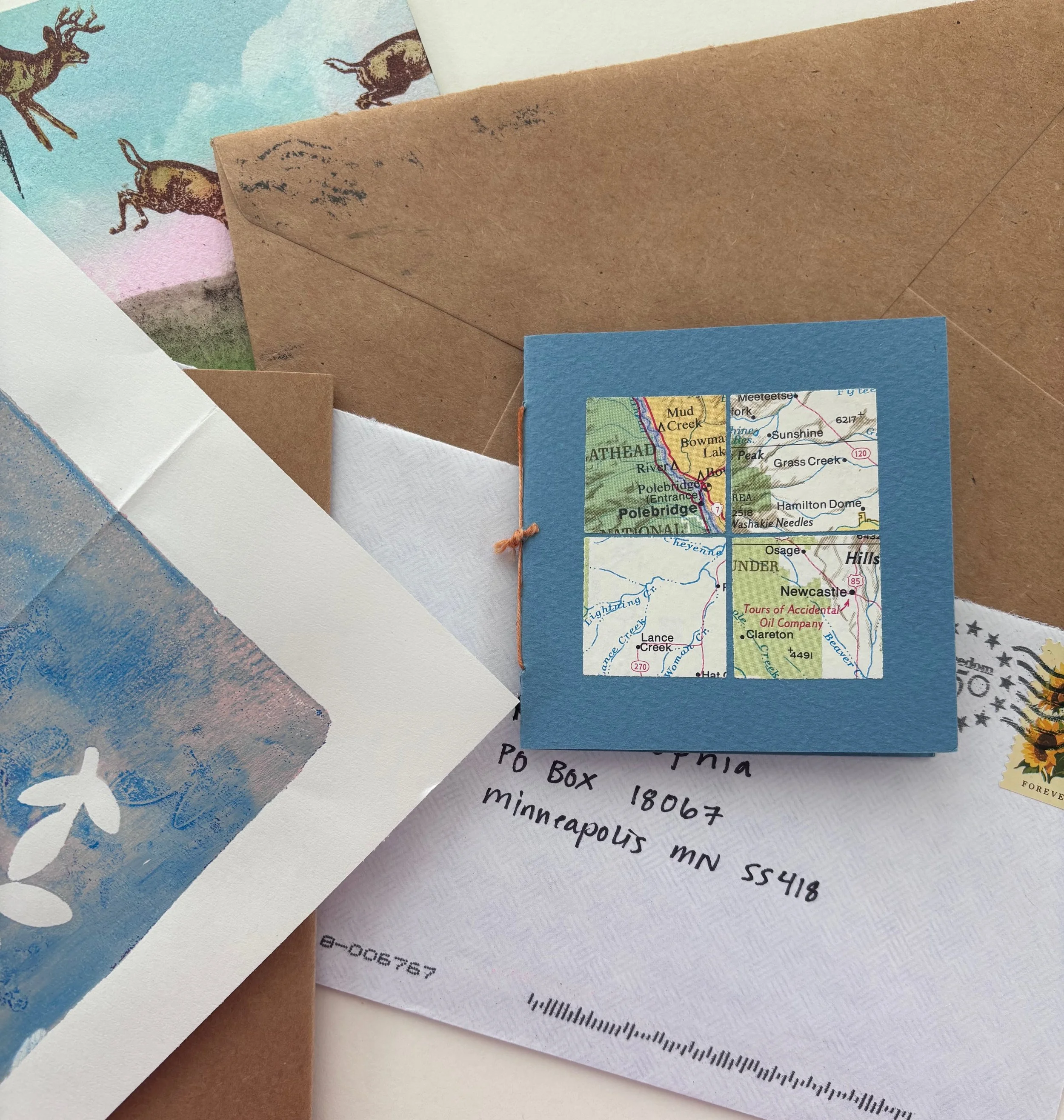 A pile of small original art and envelopes