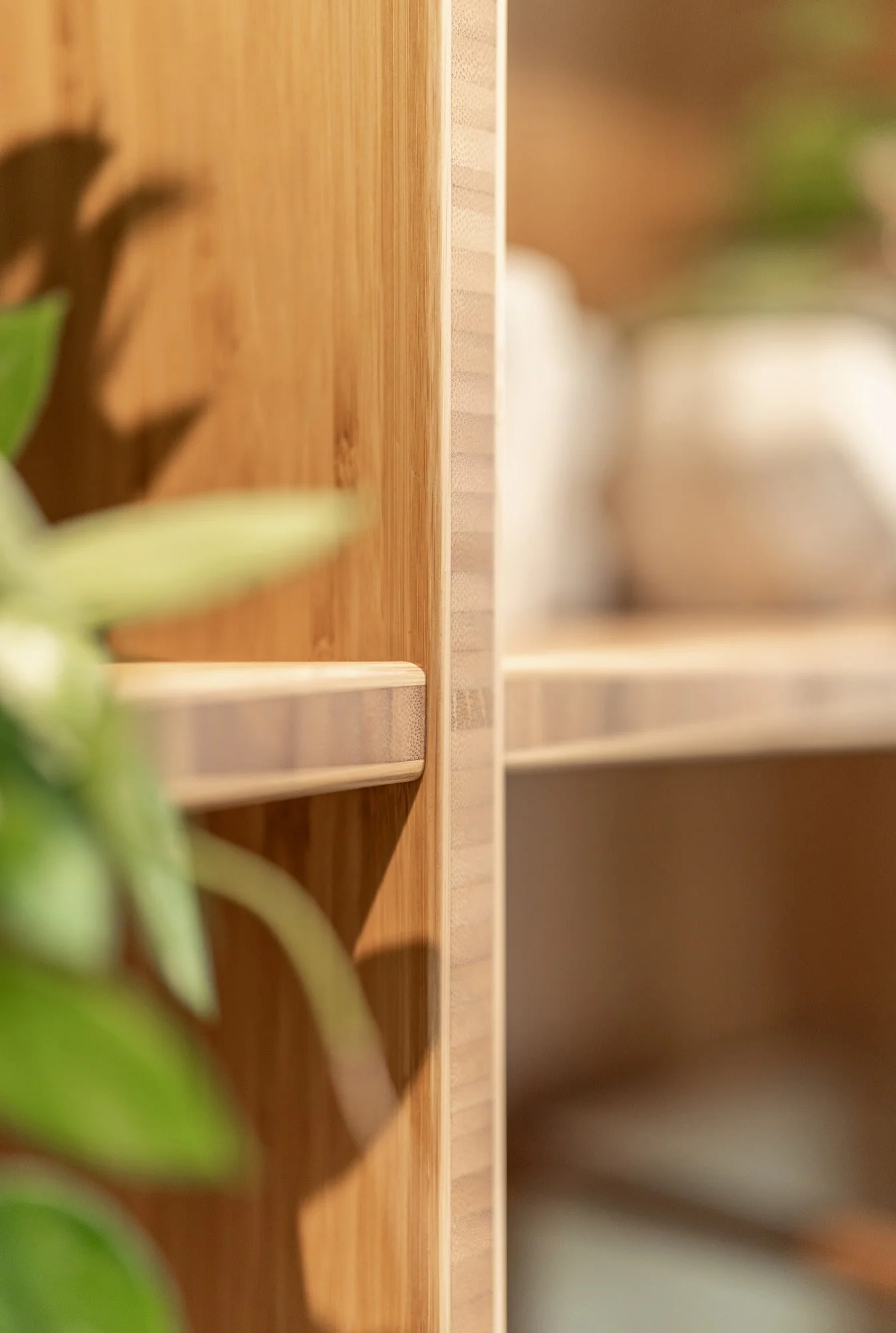 Close up of curved oak shelving with soft natural material details