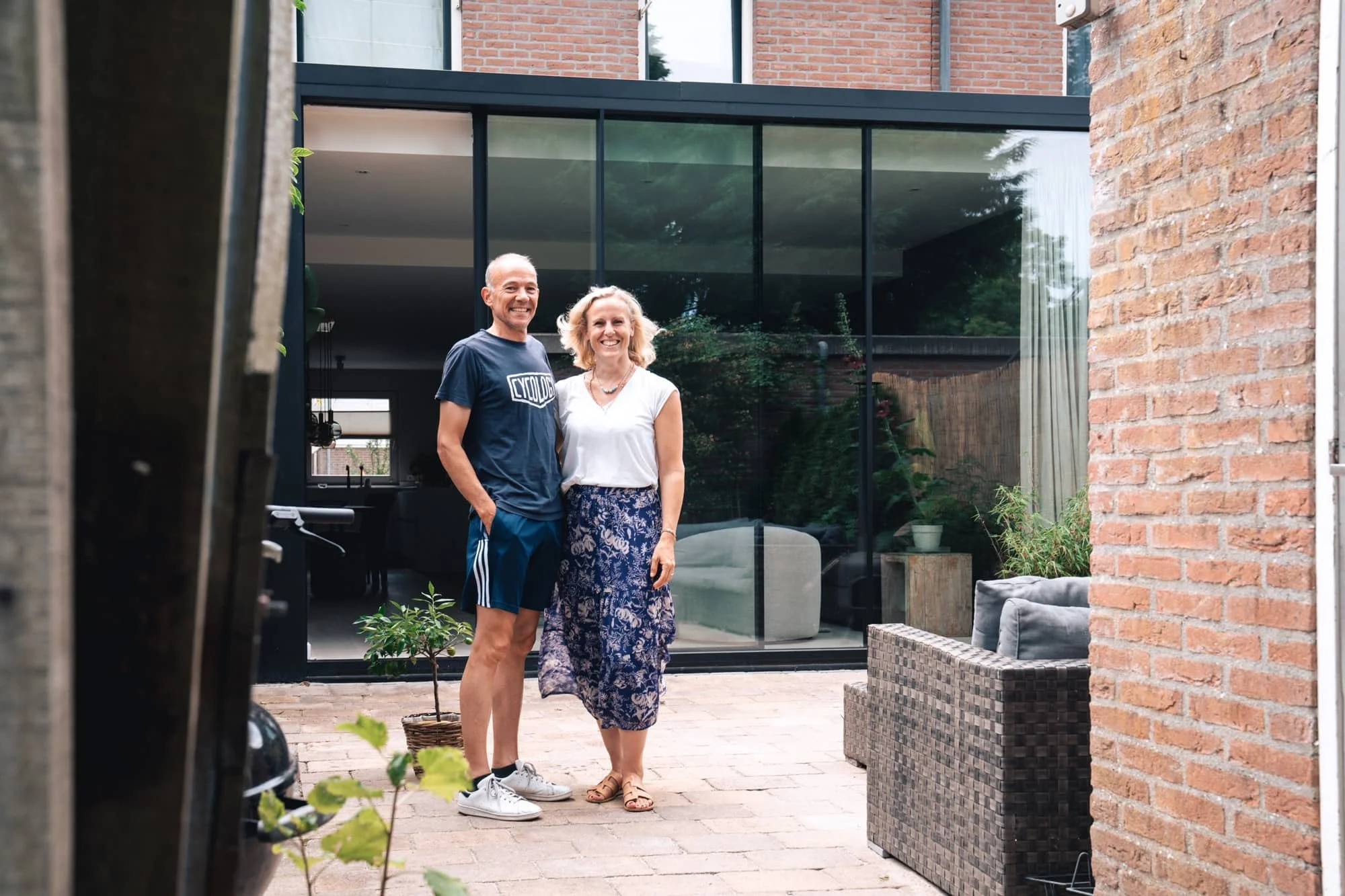 Family portrait in front of a modern black rear extension with lush garden setting