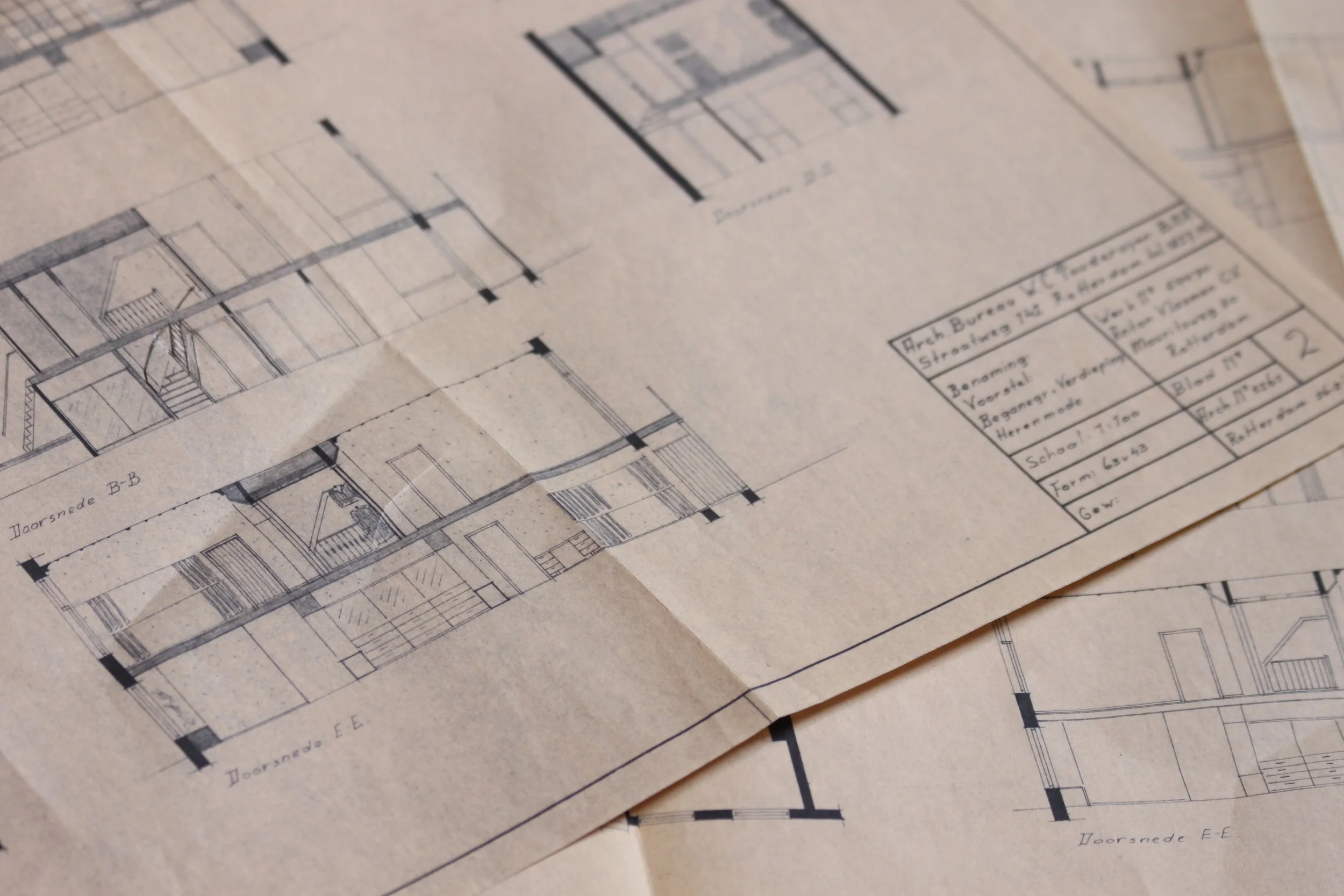 Architectural blueprints with detailed drawings of a building structure and floor plans.