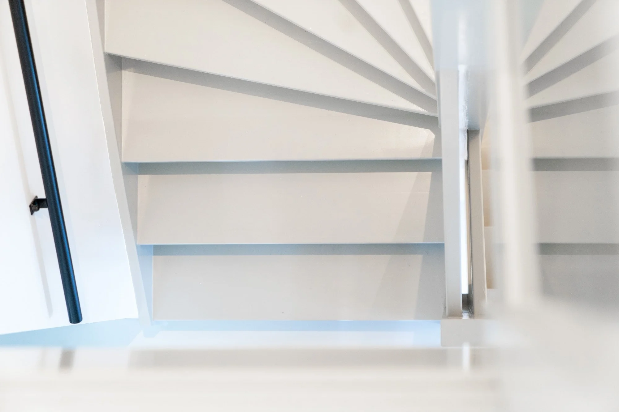 White staircase detail with soft daylight and minimal architectural lines