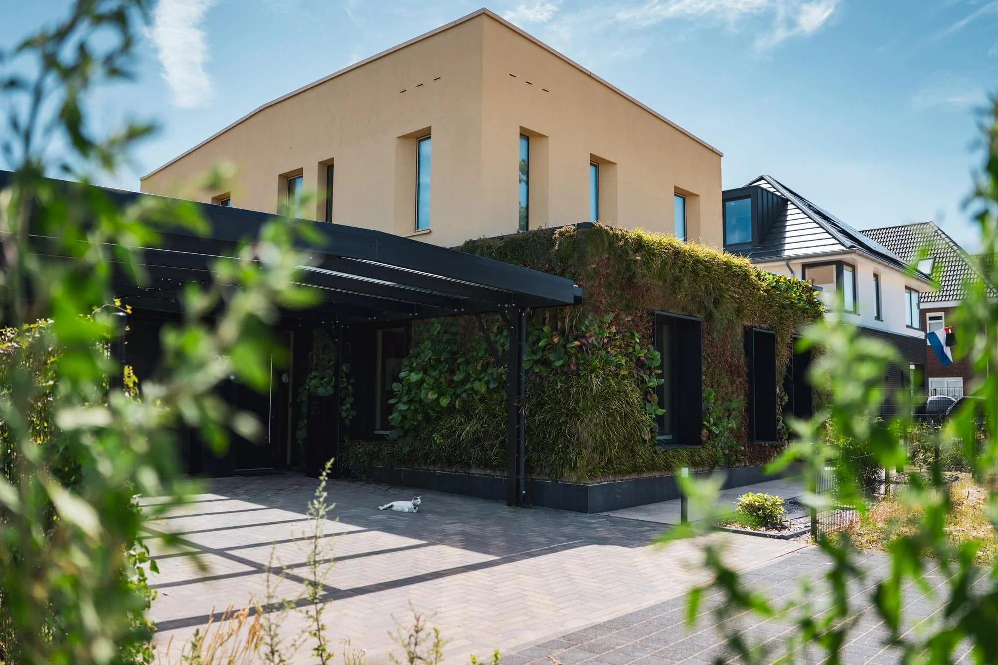 Modern beige villa with integrated greenery, terrace and shaded outdoor area