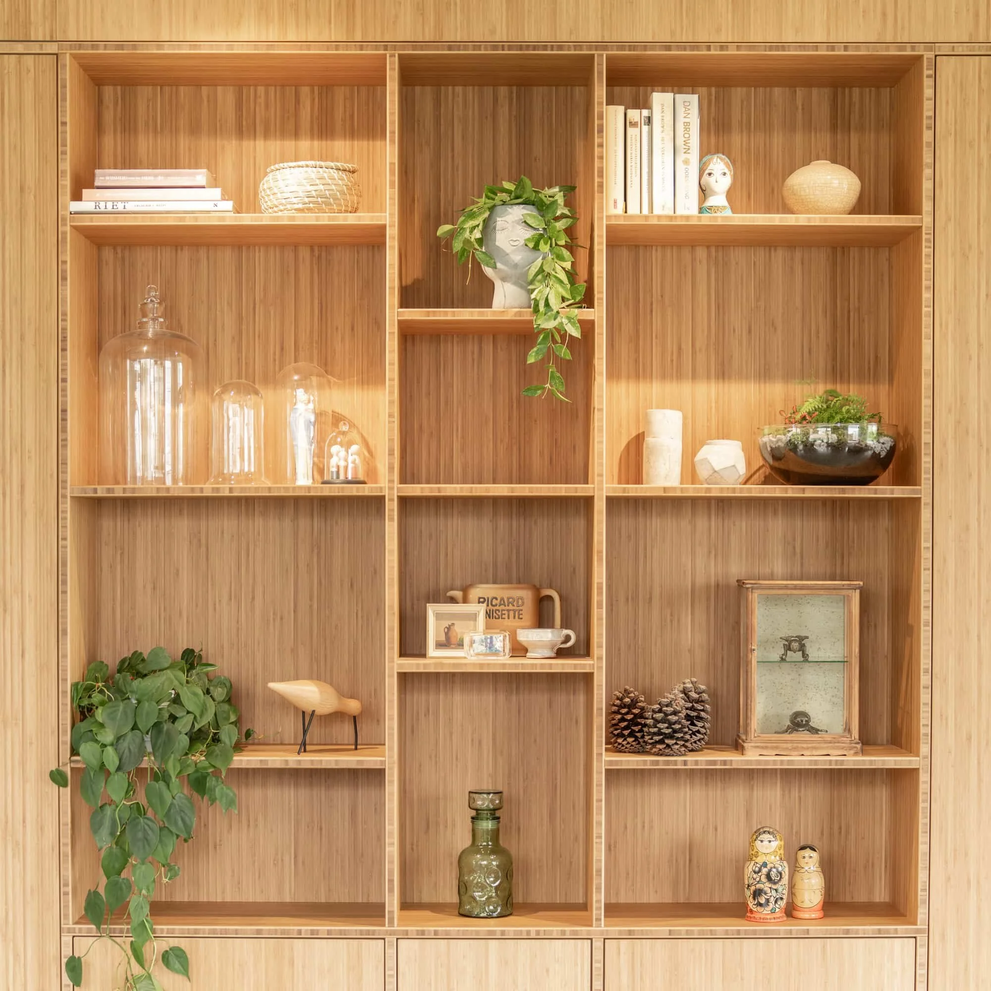 Bespoke oak shelving wall with plants, ceramics and warm integrated lighting