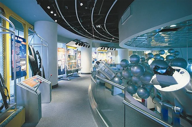 A spiral stair and glass elevator (think the Apple store but 10 years earlier) brings visitors back up to the second floor through a molecular sculpture.