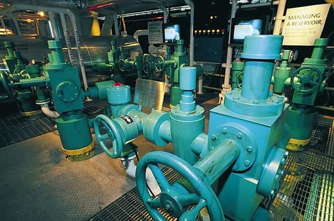 Recreated well heads—the real ones are solid stainless steel— contained rotary sensors that groups of visitors used to control well output.