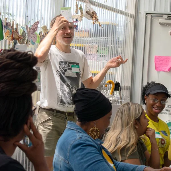 Participant playing a game and laughing with fellow participants