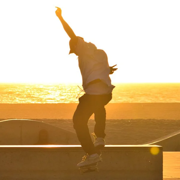 Skateboarder catching air at Venice Beach at sunset
