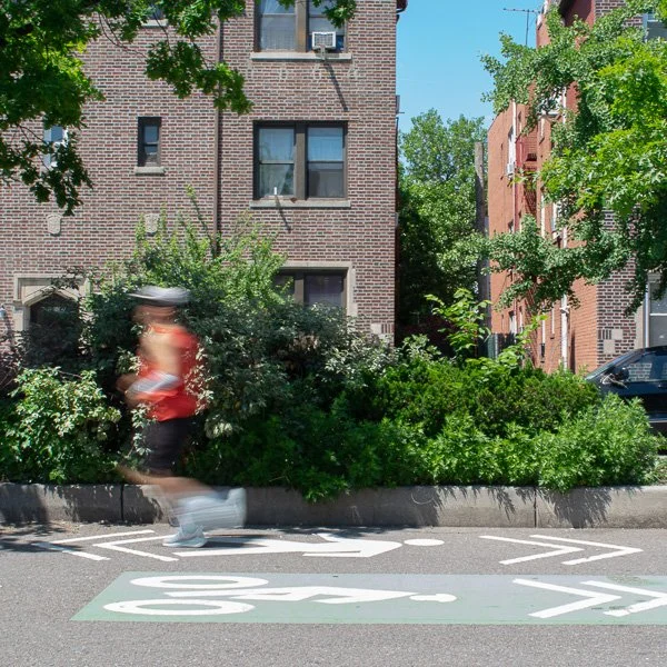 Motion-blurred Queens resident running down 34th Avenue