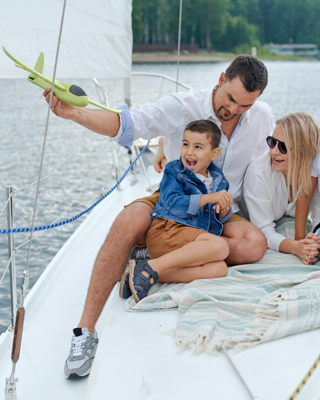 Family enjoying a sunny day together on a sailboat