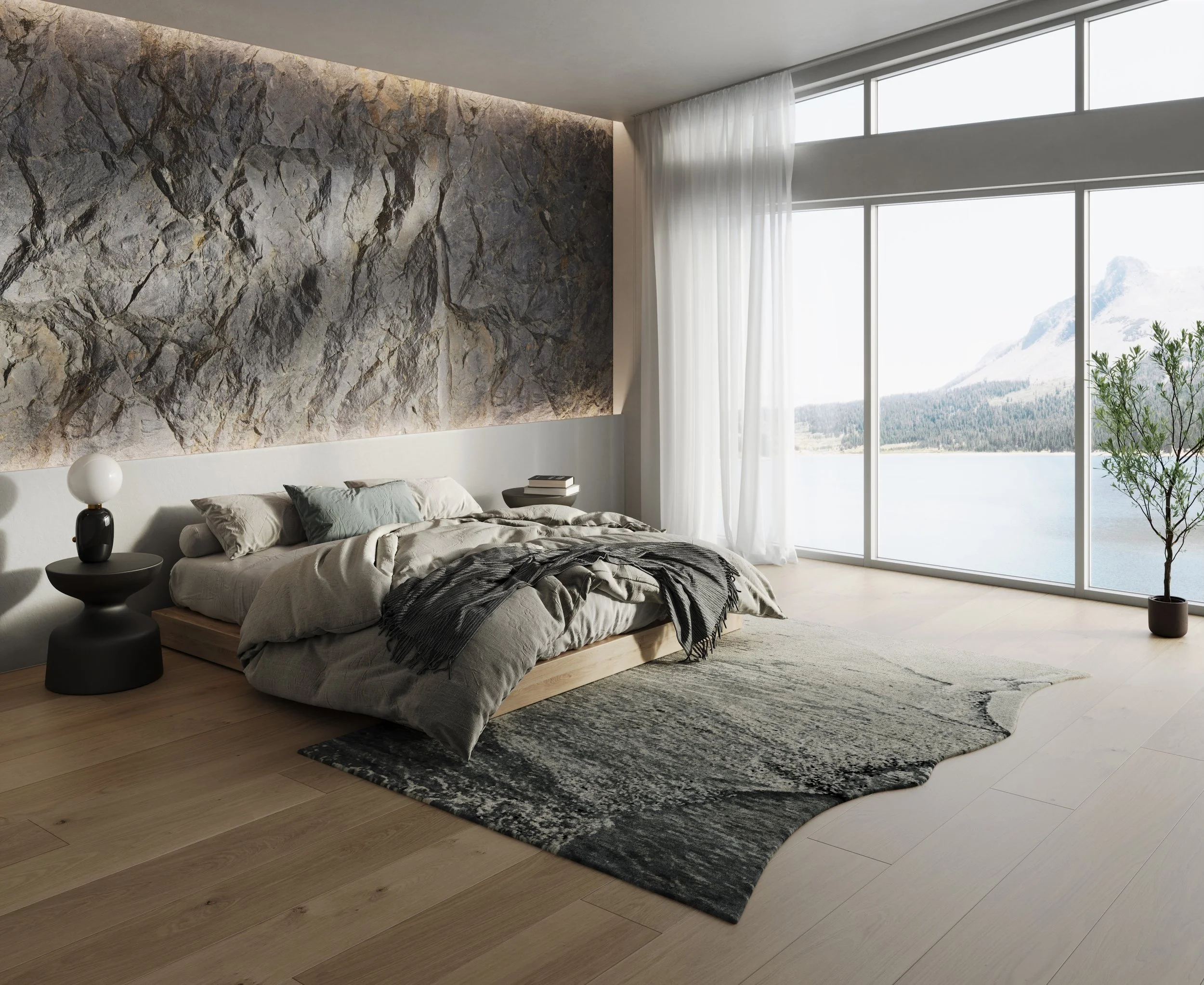 Modern bedroom with a stone accent wall, low platform bed, black side table and lamp, floor-to-ceiling windows, and a mountain lake view.