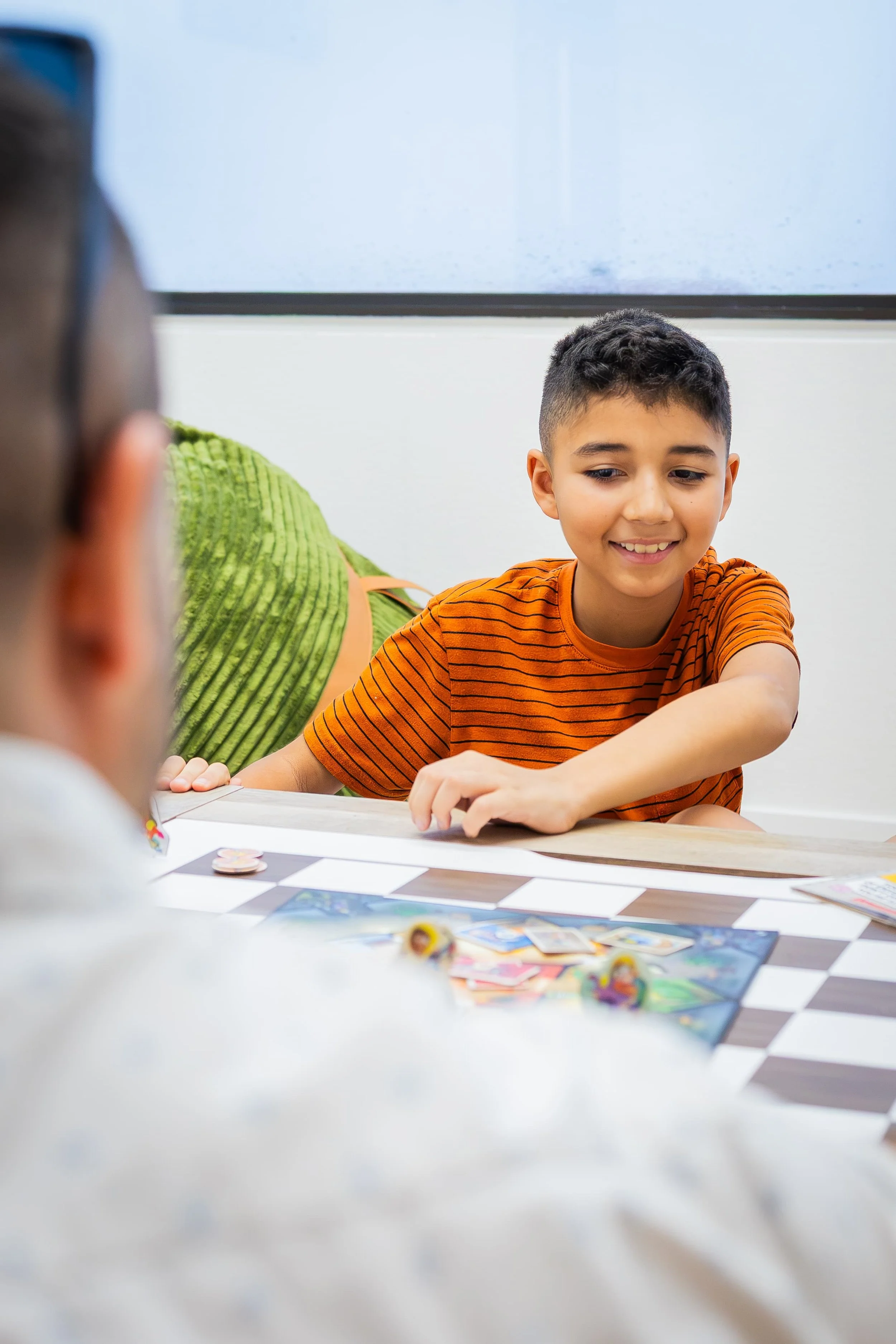 Young boy playing a game during a therapy session with Anthony Esquibel.