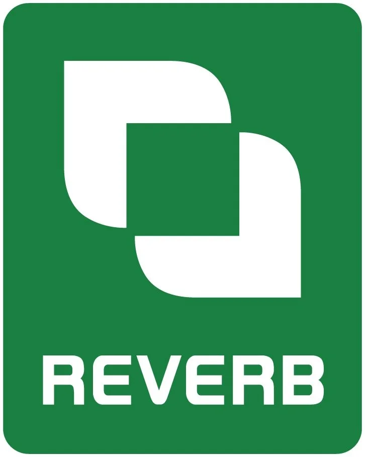 Green rectangular sign with white geometric logo and the word 'REVERB' underneath.