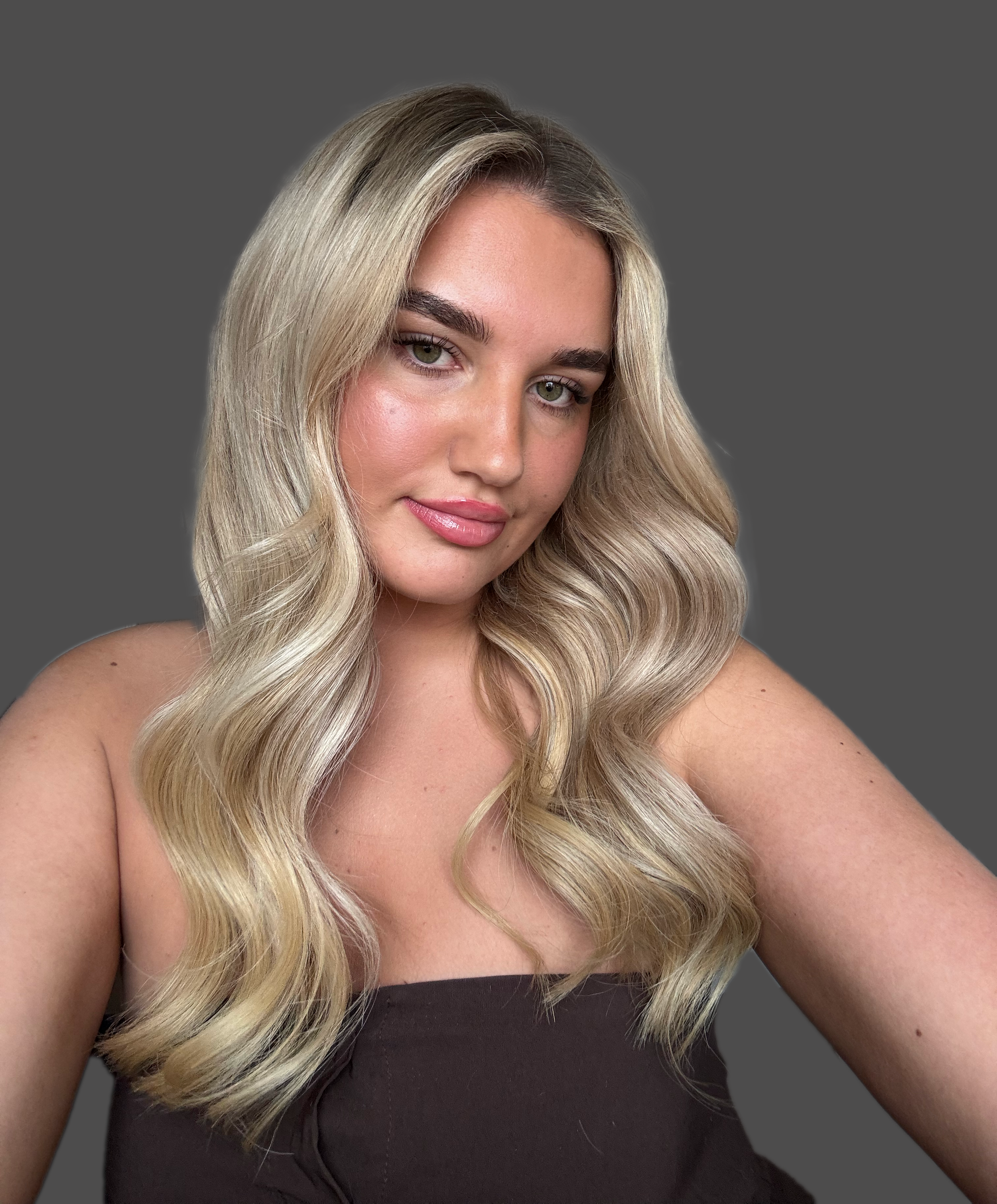 Close-up of a young woman with long, wavy blonde hair
