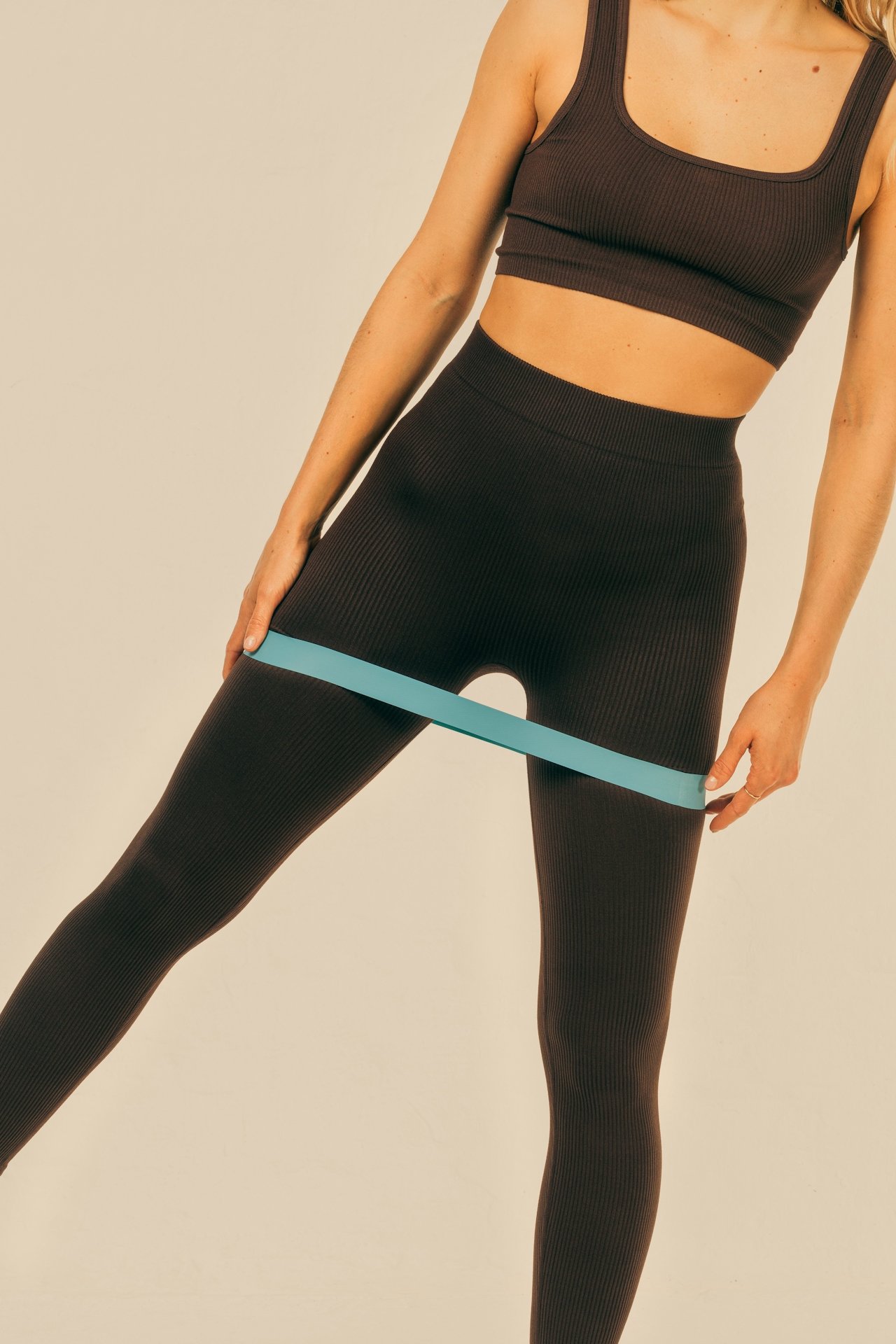 woman bending using a resistant band on her legs during Pilates
