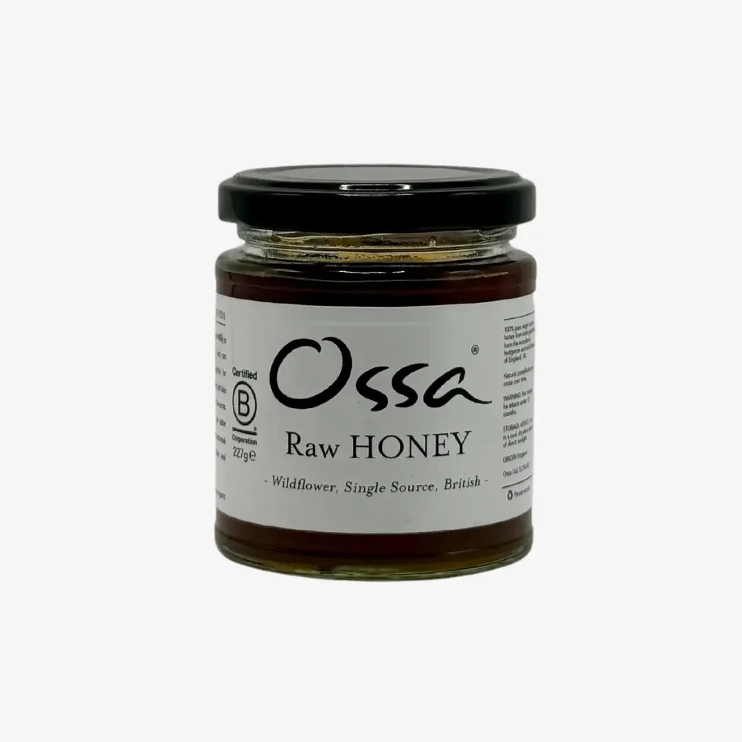 Ossa raw honey in a glass jar with black lid and white wrap round label