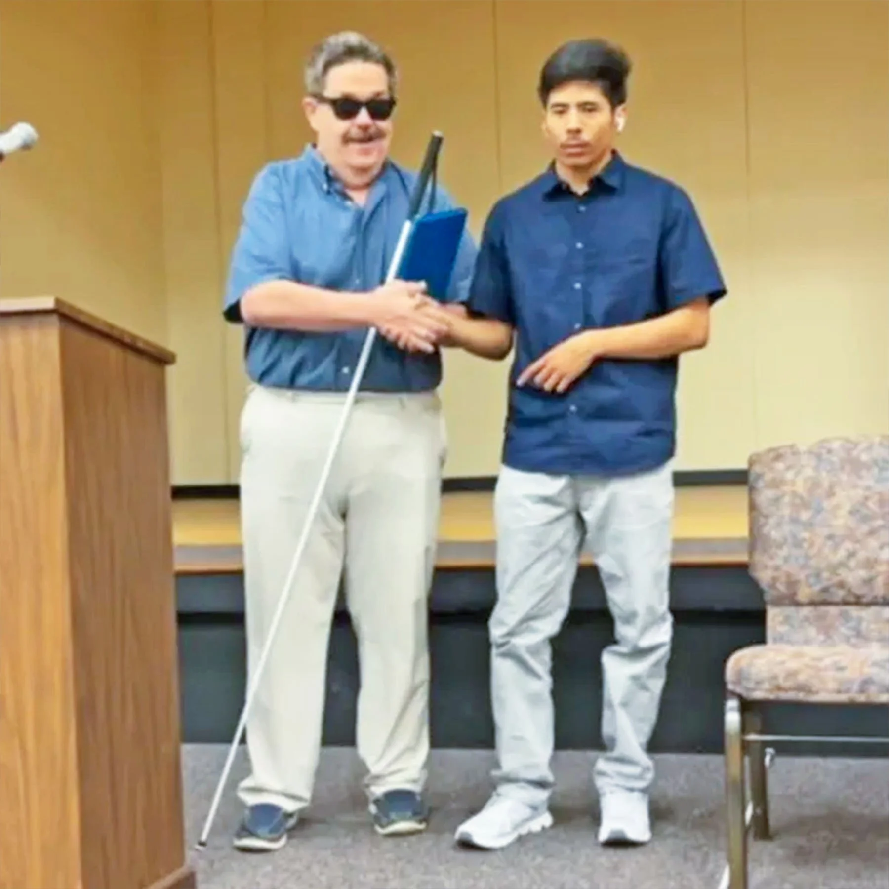Blind student Alfredo Garcia (right), shakes hands with faculty (left), as he graduates from Criss Cole school for the blind in Austin, Tx. 