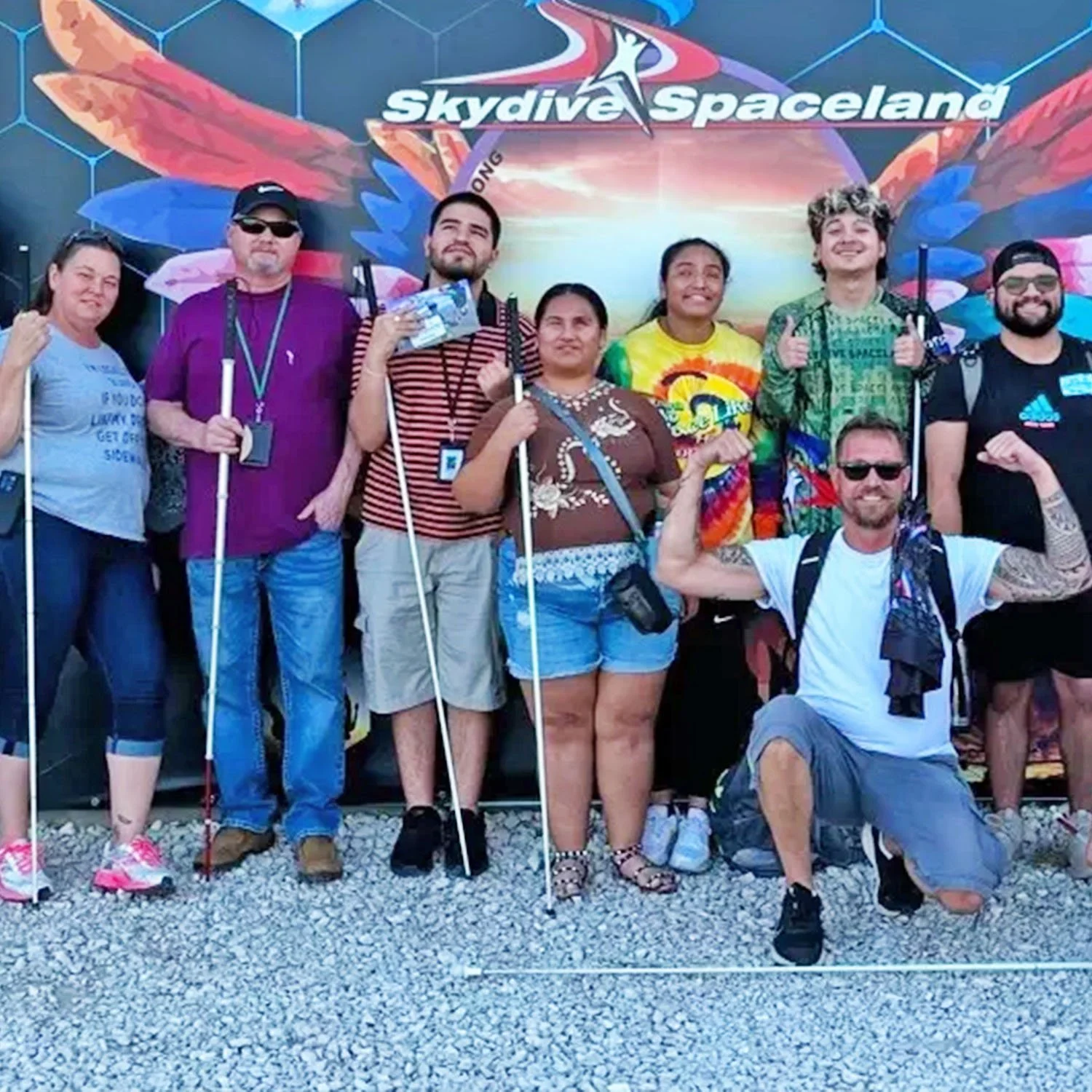 A group of visually impaired and blind individuals celebrate a joyful outing to Skydive Spaceland.