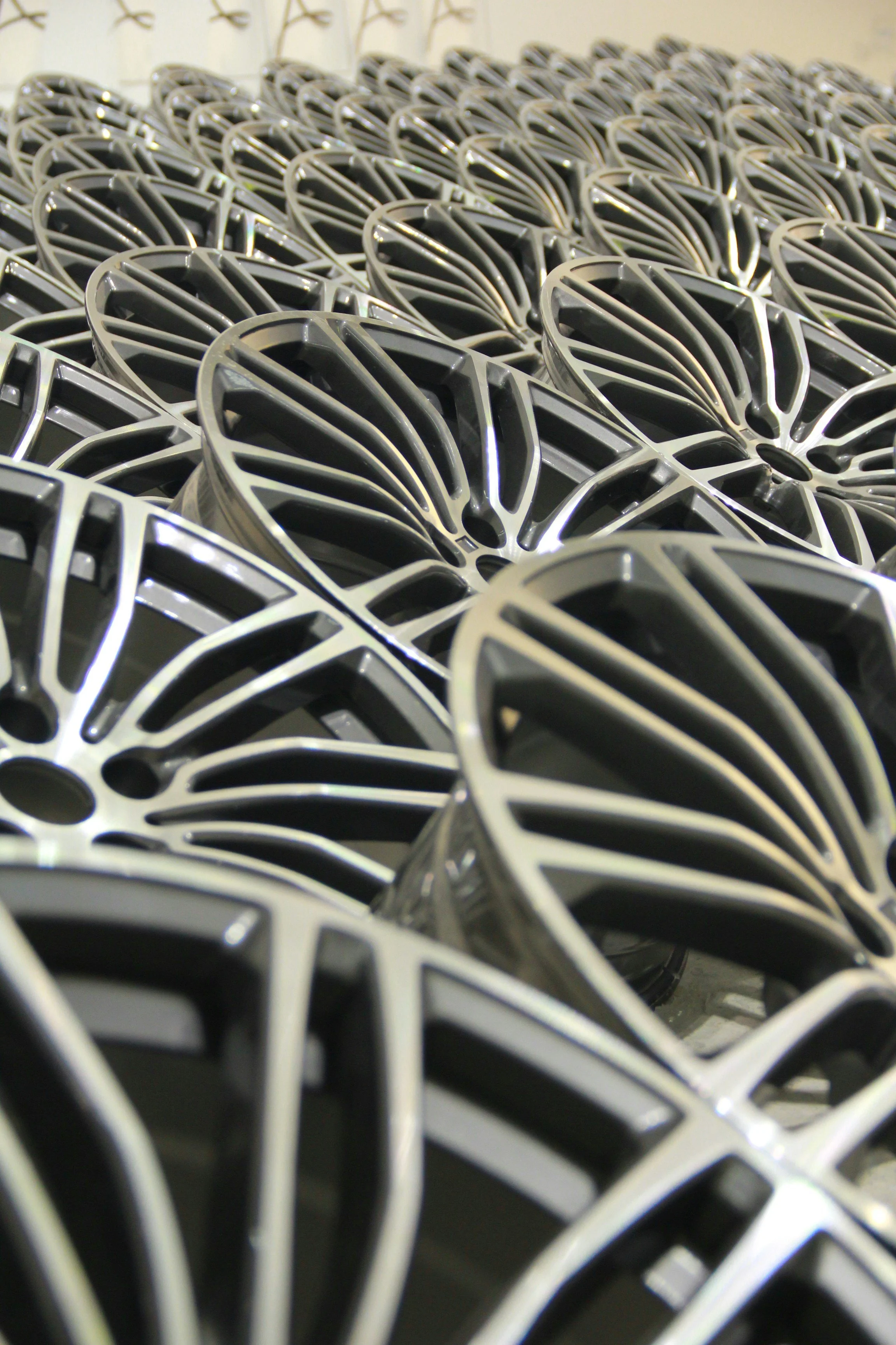 Aluminum wheel scrap stacked in rows.