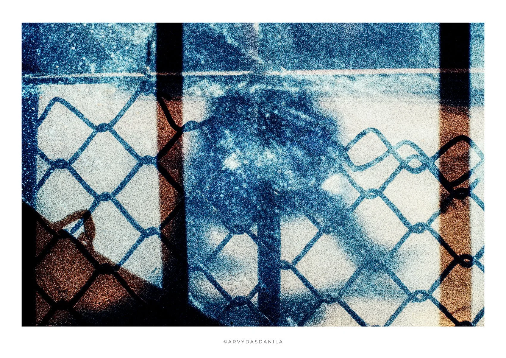 Graph of a declisilouhette  of a human figure blue mood, truly unique dreamlike visual extremely strong impression visible through chain-link fence with a blue textured background.