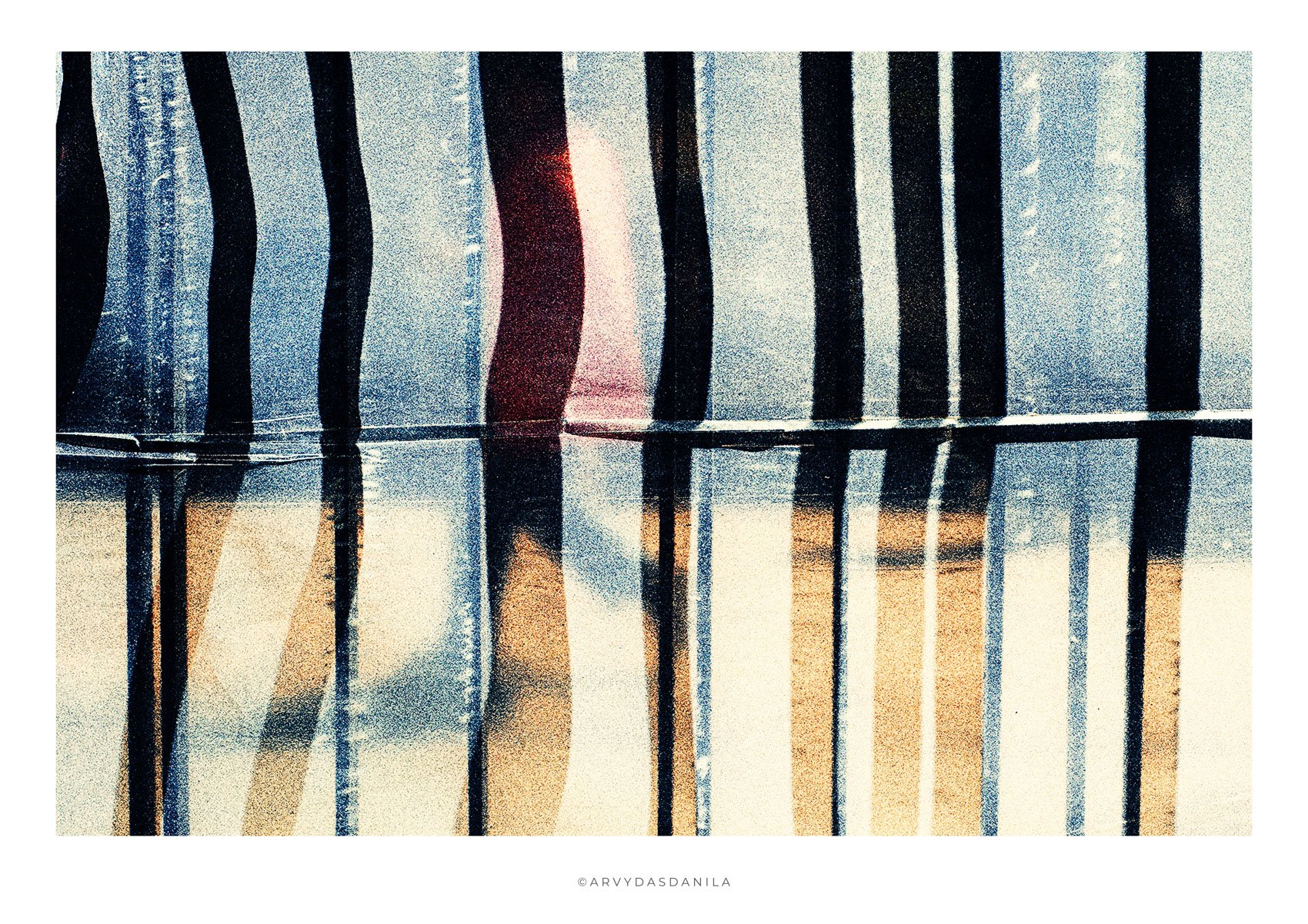 Abstract image of vertical black and white striped pattern, and a soft light source creating a glow in the background with barely visible person.