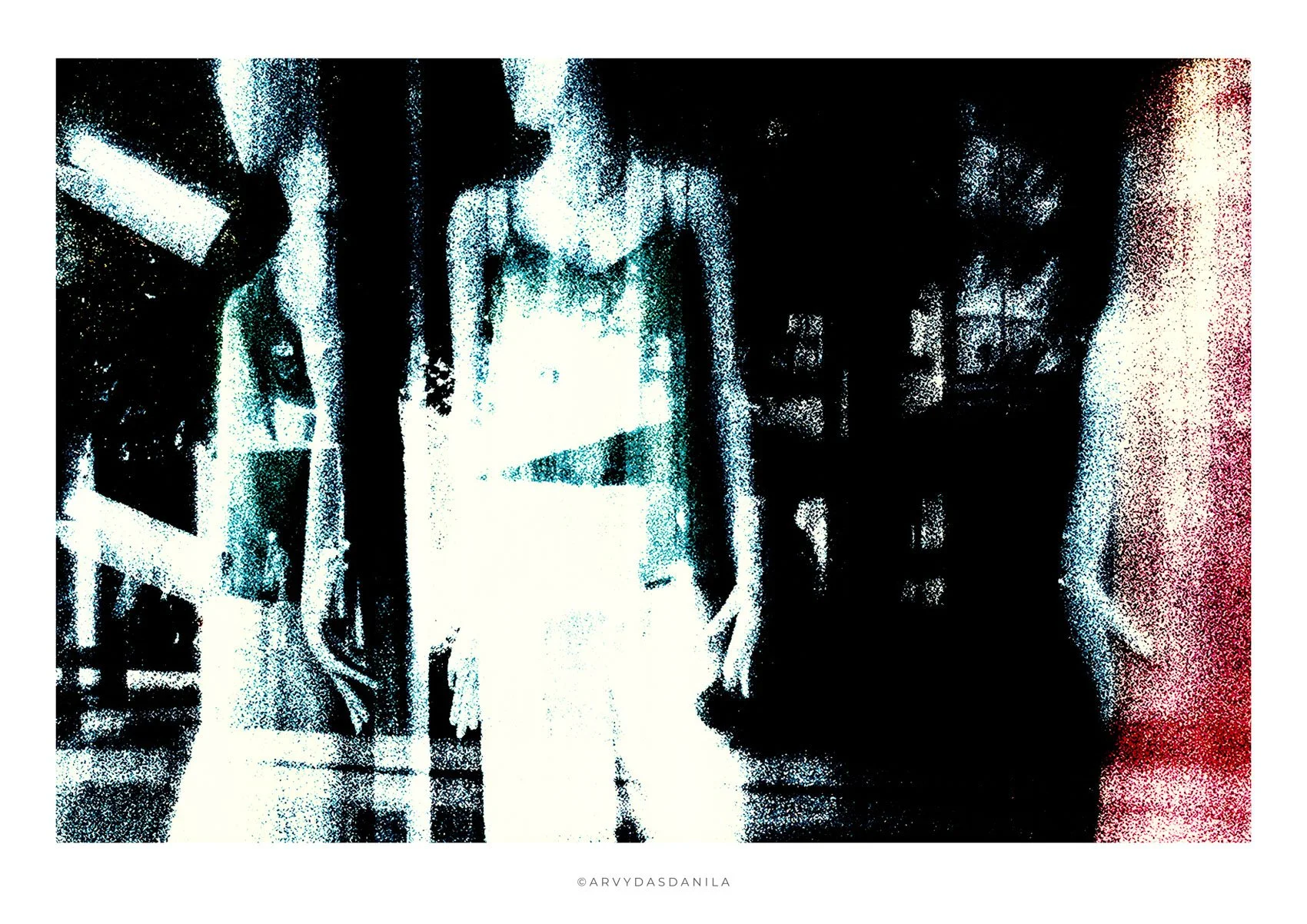 A pixelated photo of a woman in a light dress standing in an indoor space with industrial shelving on the left and dark background on the right.