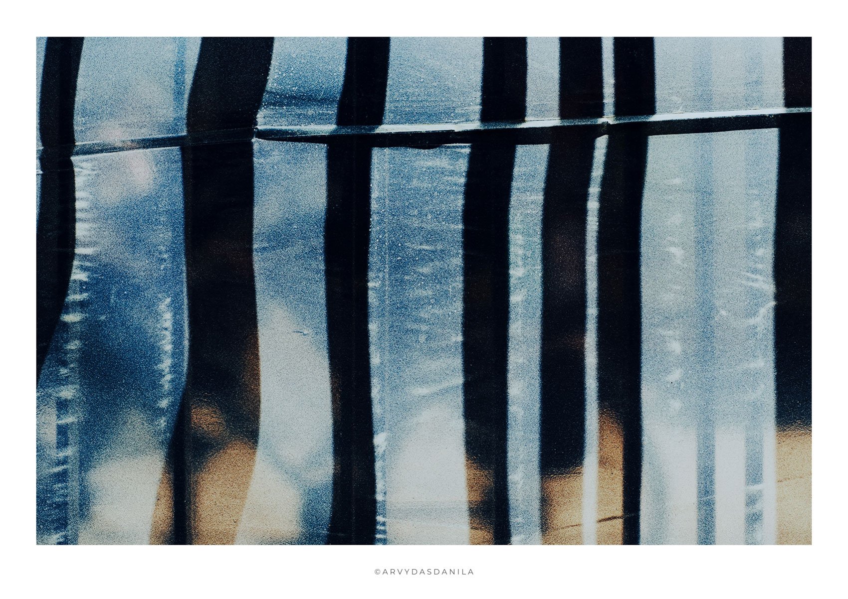 Reflection of vertical black bars on a glabstract blue with distorted shadowsimage, truly artistic photograph unique in it's character with a blurred mystic and textured background.